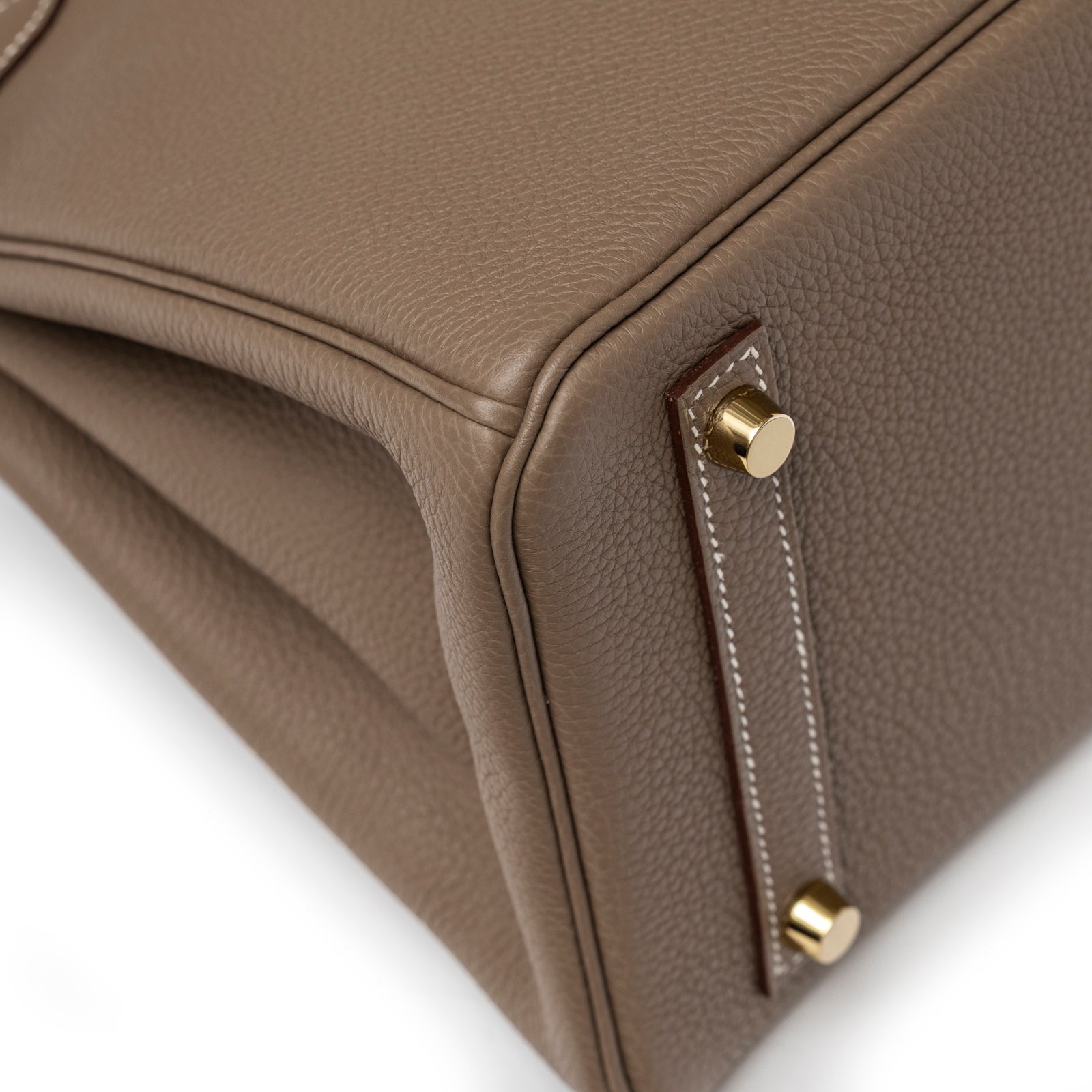 Close-up of leather texture and gold feet on corner of Hermès Birkin 30 Etoupe Togo Gold Hardware handbag