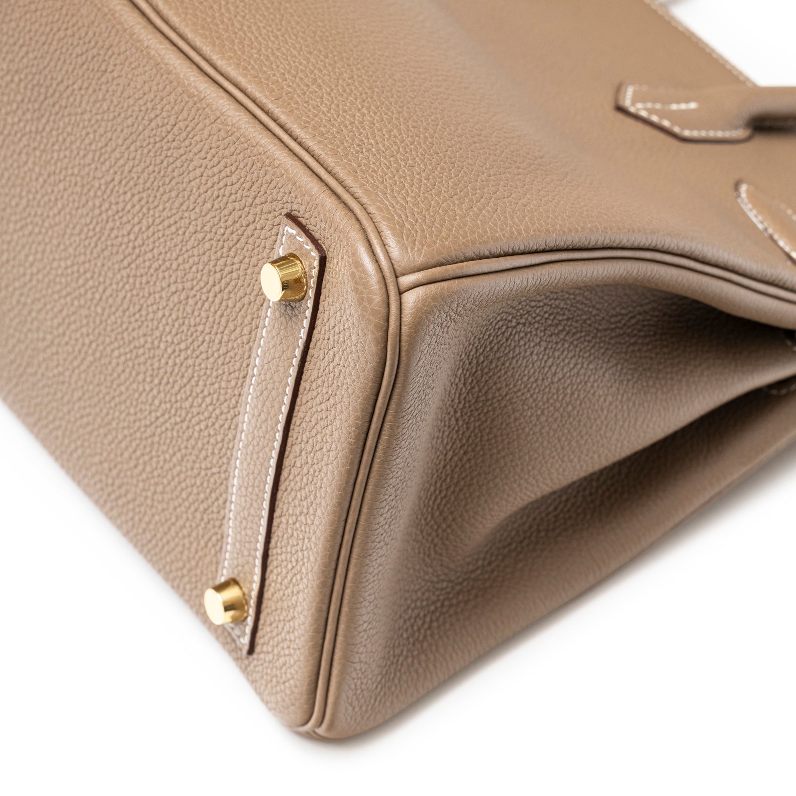 Close-up of bottom corner and gold hardware of Hermès Birkin 30 Etoupe Togo Gold Hardware bag showing texture and stitching detail