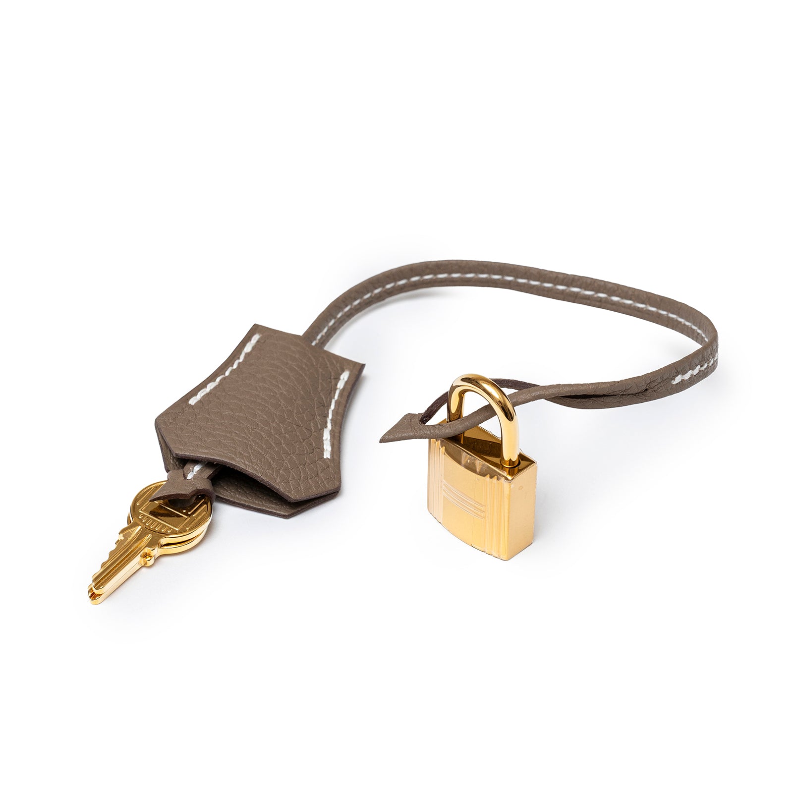 Close-up angled view of Hermès Birkin 30 Etoupe Togo Gold Hardware leather clochette with keys and gold lock detail