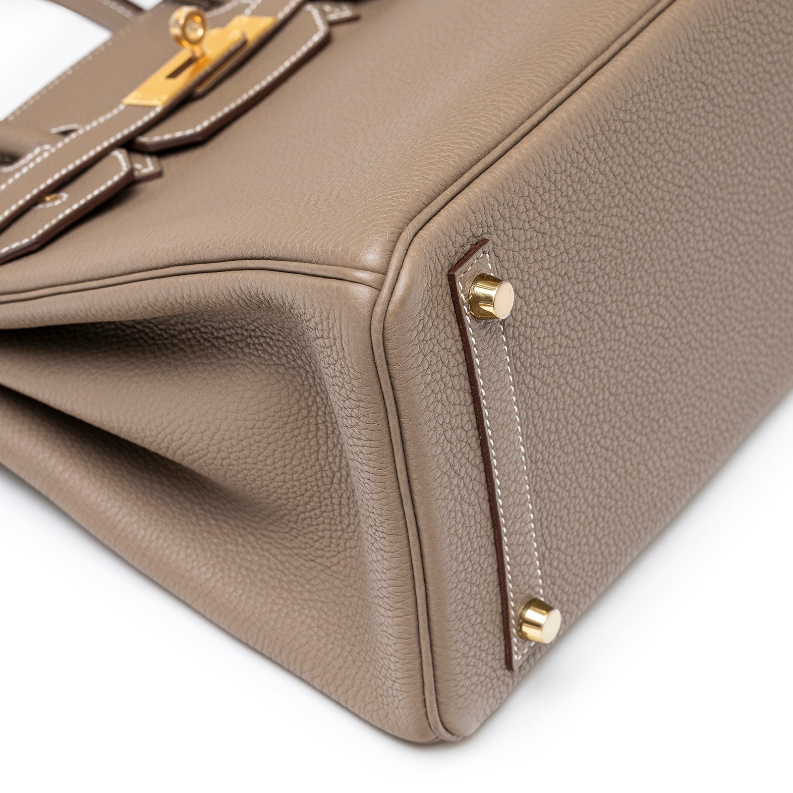 Close-up of bottom corner and gold hardware feet on Hermès Birkin 30 Etoupe Togo Gold Hardware handbag