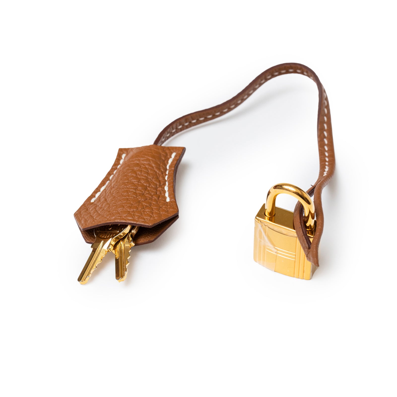 Close-up of Hermès Birkin 30 Gold Togo Gold Hardware leather key clochette and gold lock with strap detail