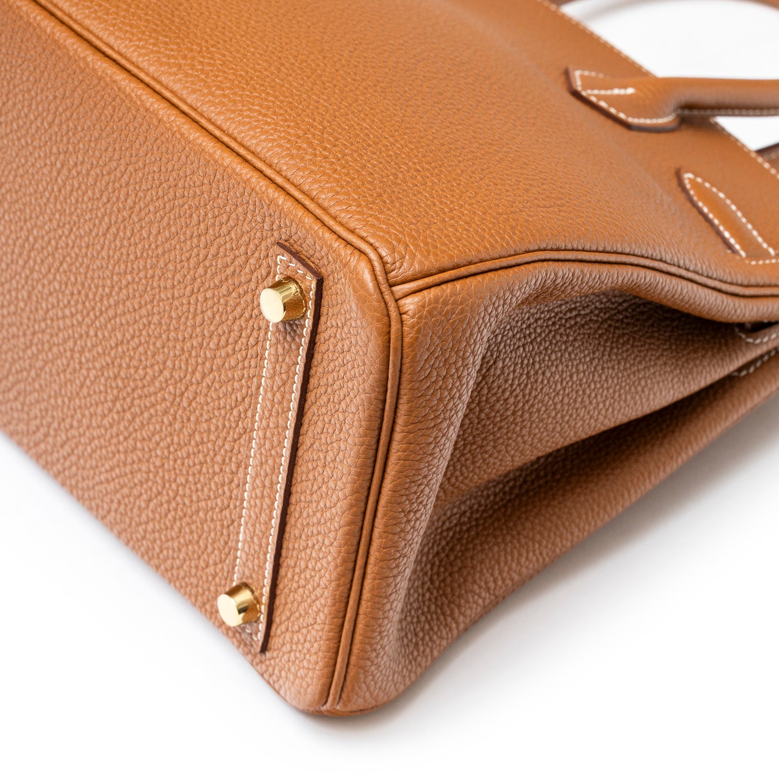 Close-up angled shot of Hermès Birkin 30 Gold Togo Gold Hardware showcasing leather texture and gold feet detail