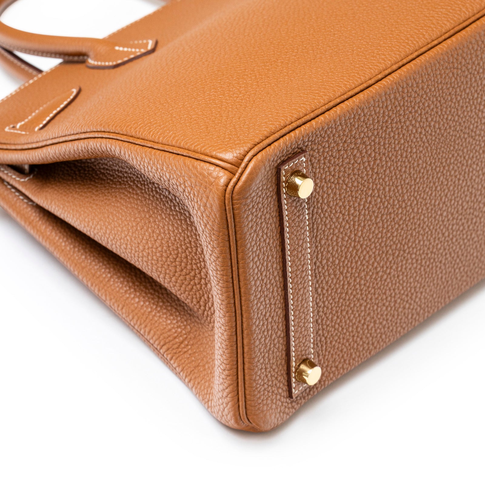 Close-up angled view of Hermès Birkin 30 Gold Togo Gold Hardware showing texture and metal feet details