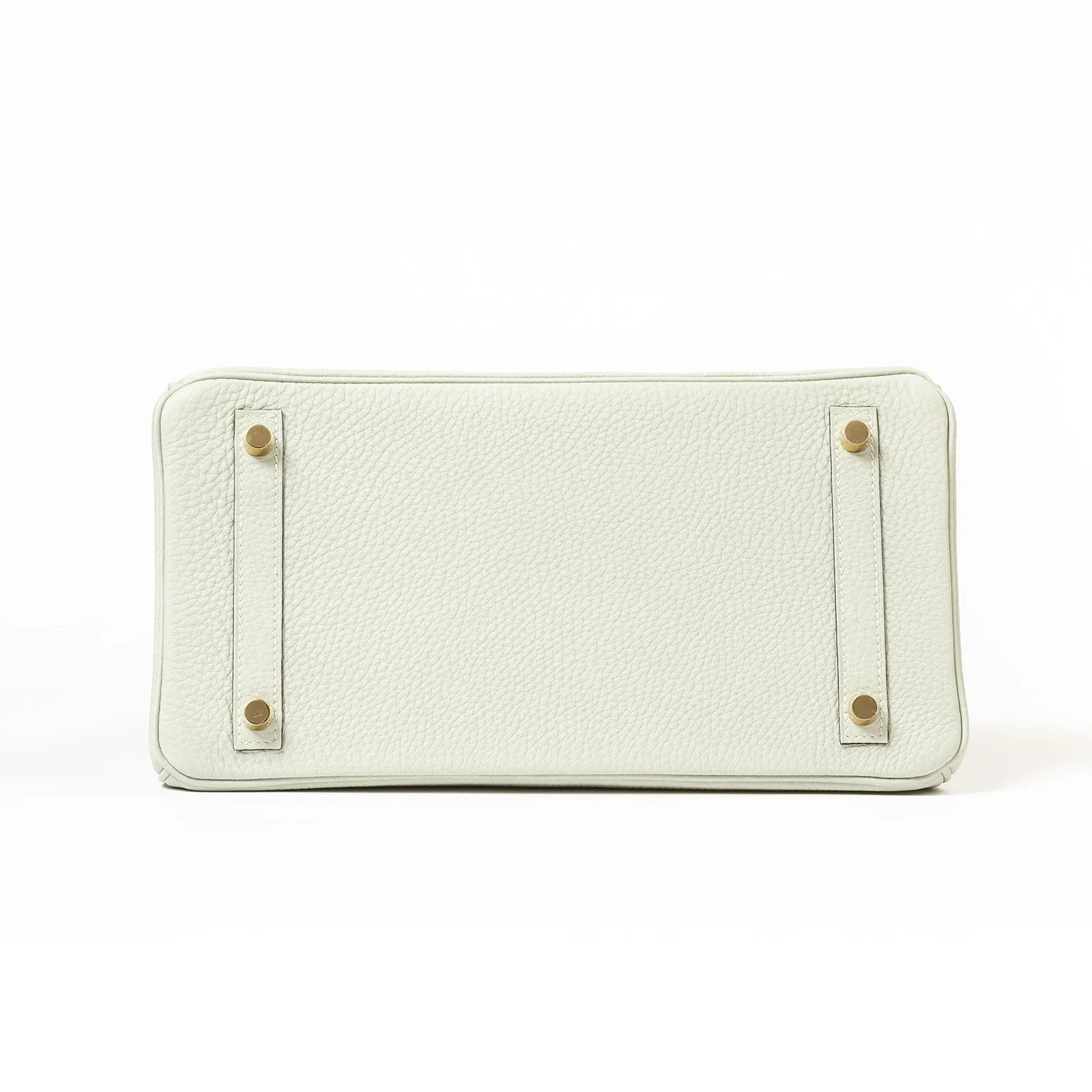 Bottom view of Hermès Birkin 30 in gris neve togo leather, showcasing gold hardware feet and textured leather base.