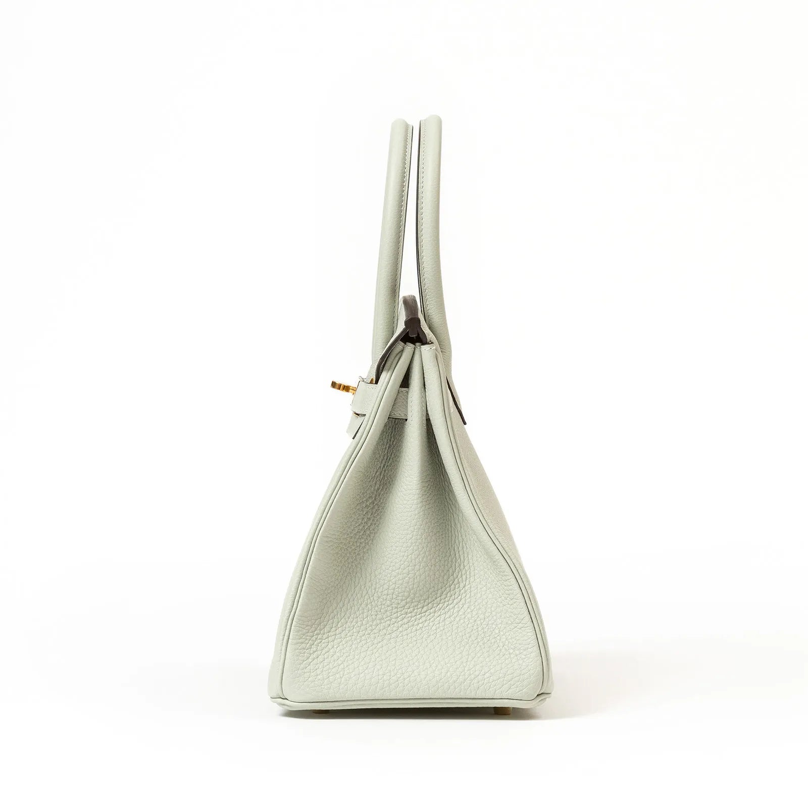 Side profile of Hermès Birkin 30 in Gris Neve Togo leather with visible gold hardware and double handles