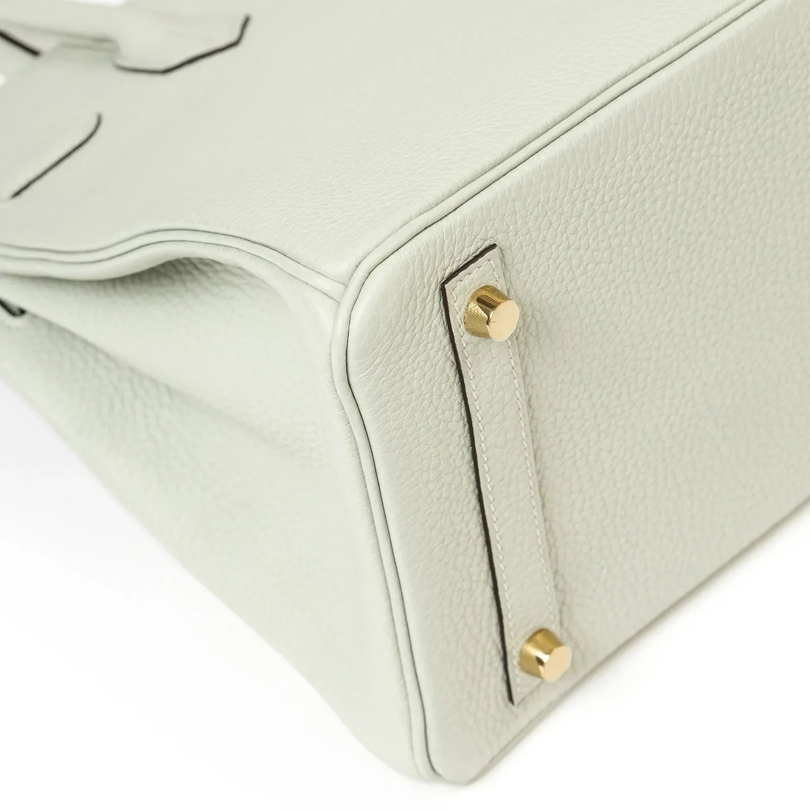 Close-up of bottom corner and gold hardware feet on Hermès Birkin 30 Gris Neve Togo leather handbag