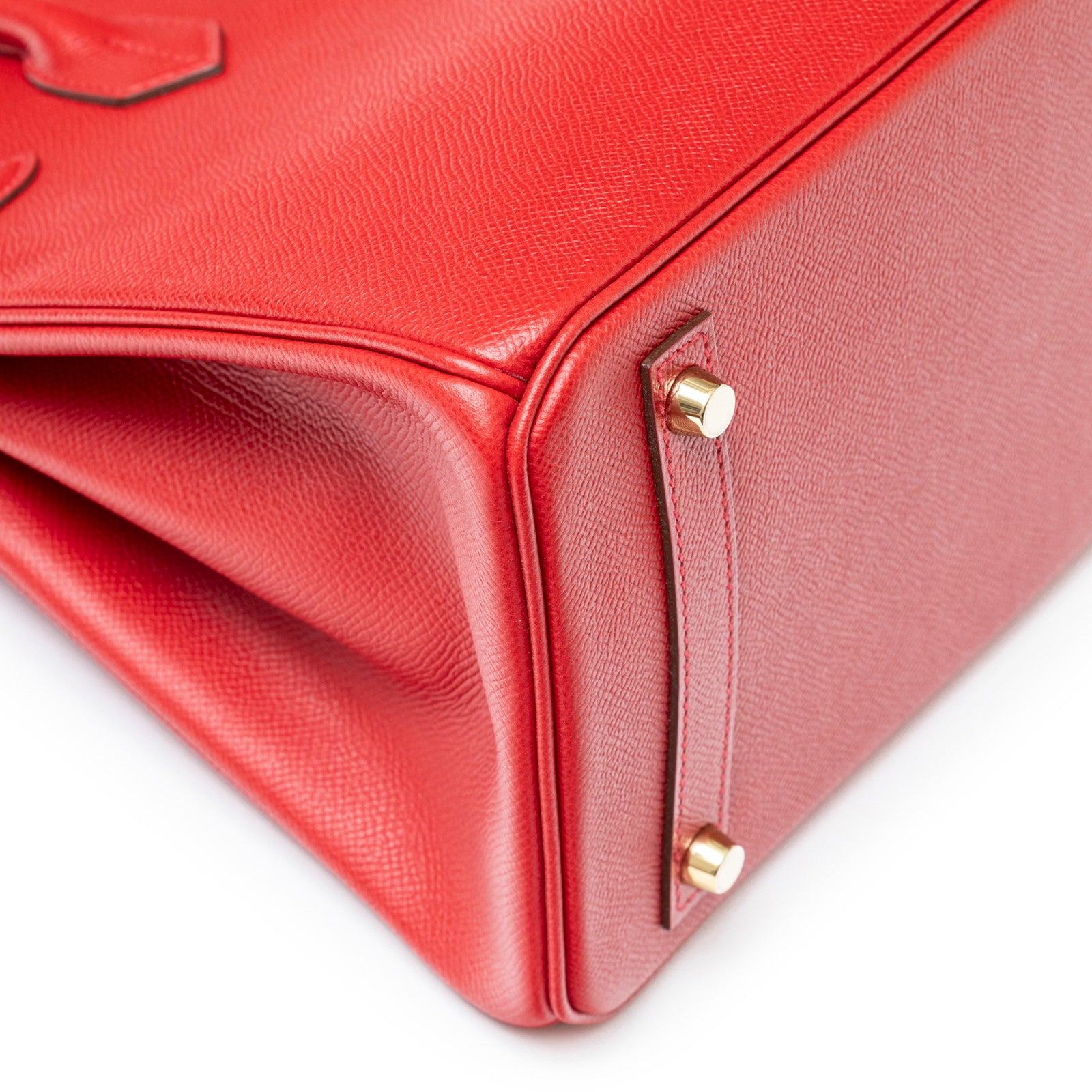 Close-up of bottom corner showing texture and gold hardware of Hermès Birkin 30 Rouge Casaque Epsom Gold Hardware bag