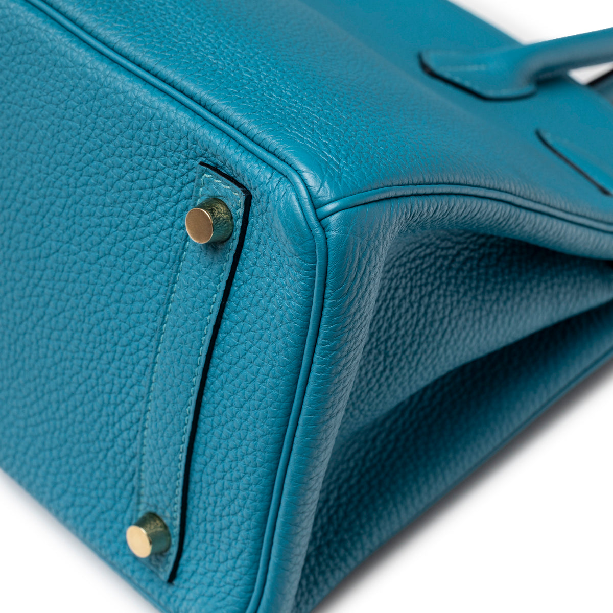 Close-up of Hermès Birkin 30 Turquoise Togo Gold Hardware corner showing gold feet and textured leather grain