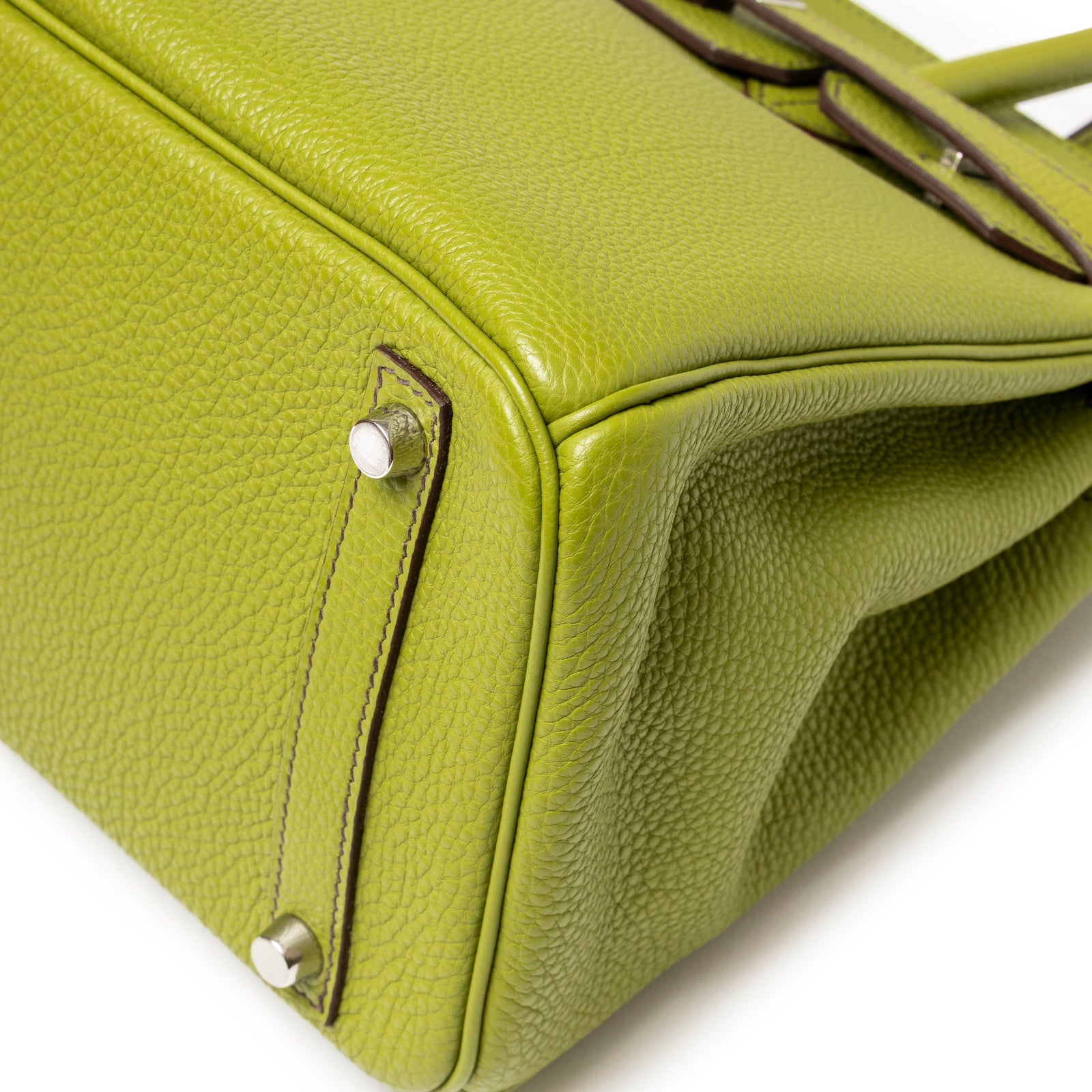 Close-up of bottom corner showing grained leather texture and palladium feet on Hermès Birkin 30 Vert Anis Togo Palladium Hardware