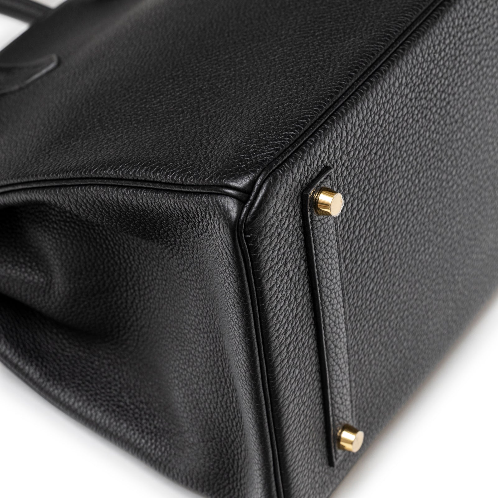Close-up of bottom corner on Hermès Birkin 35 Black Togo Gold Hardware showing textured grain and gold studs details