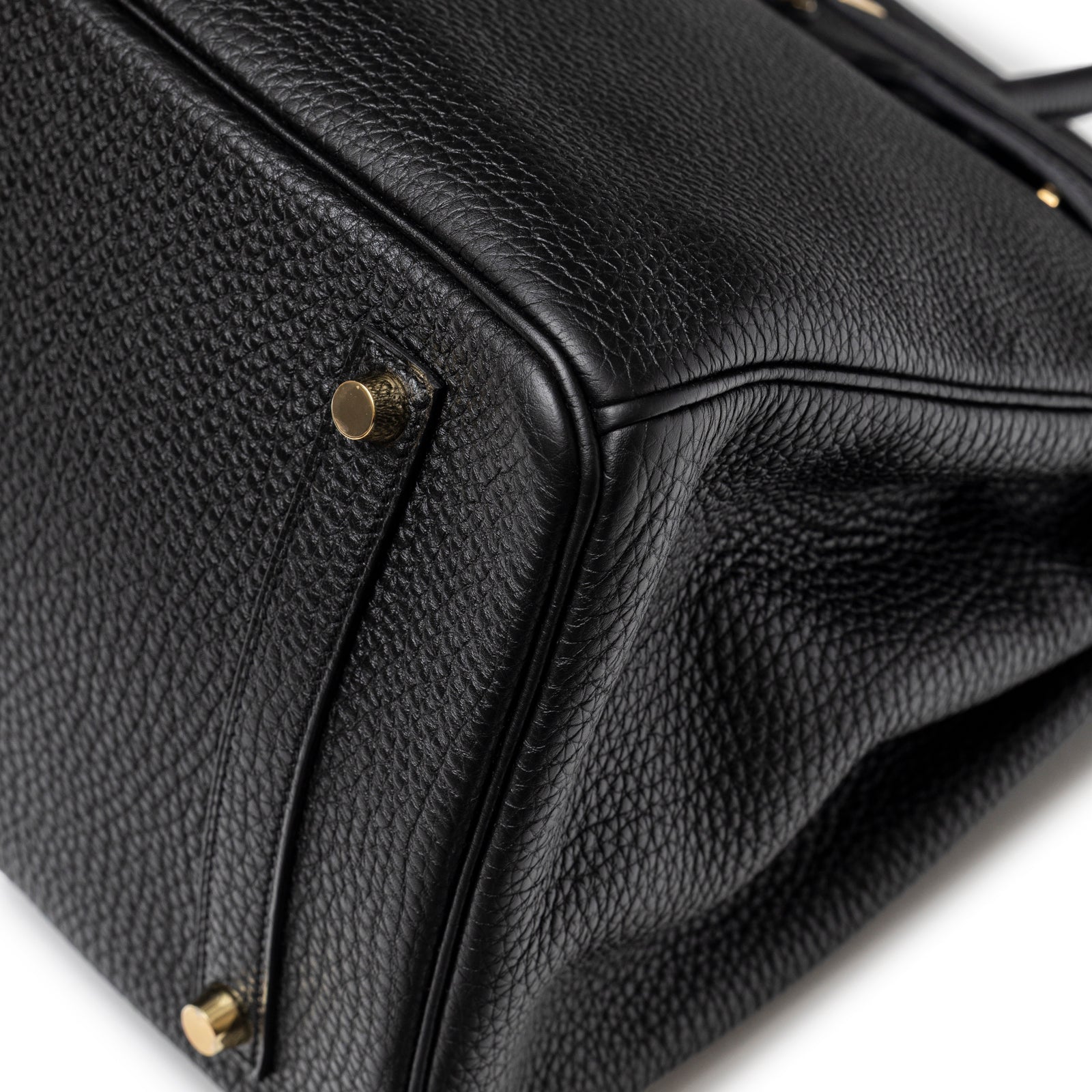 Close-up of the base on Hermès Birkin 35 Black Togo Gold Hardware showing pebbled leather and gold studs