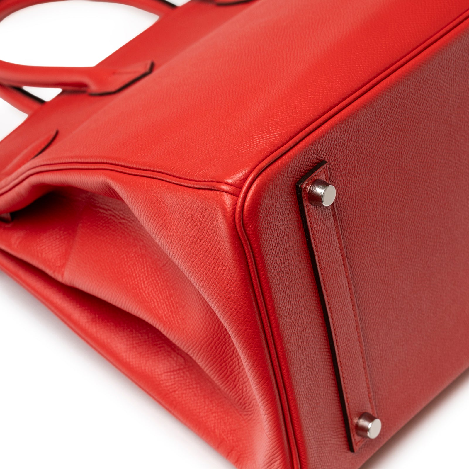 Detailed close-up of textured leather base and silver hardware feet on Hermès Birkin 35 Bougainvillea Epsom Palladium Hardware