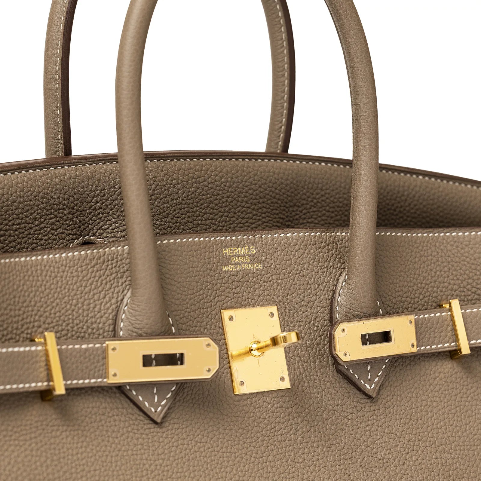 Close-up front view of Hermès Birkin 35 Etoupe Togo handbag with gold hardware and visible logo stamp.
