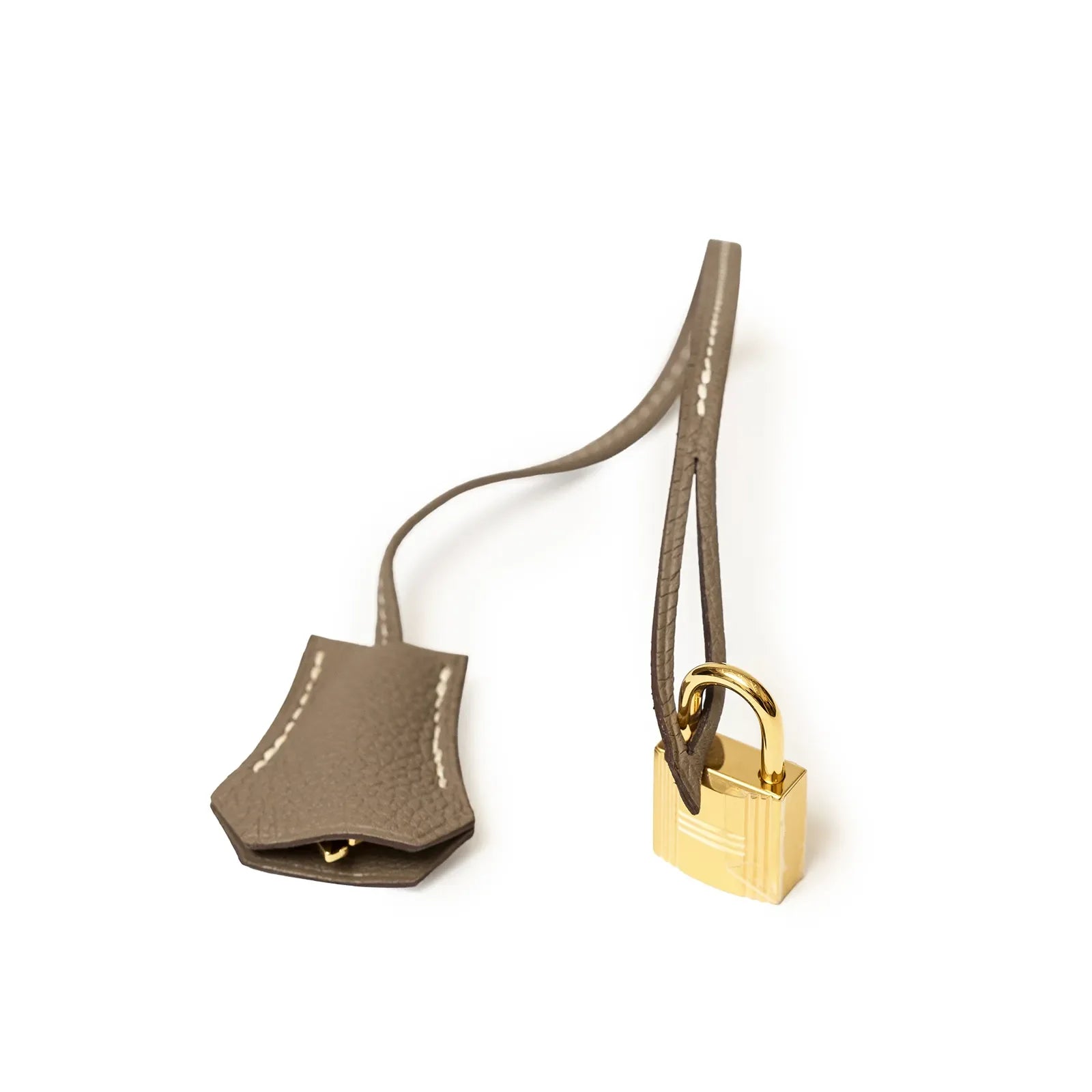 Close-up of gold lock and taupe clochette on Hermès Birkin 35 Etoupe Togo Gold Hardware accessory detail.