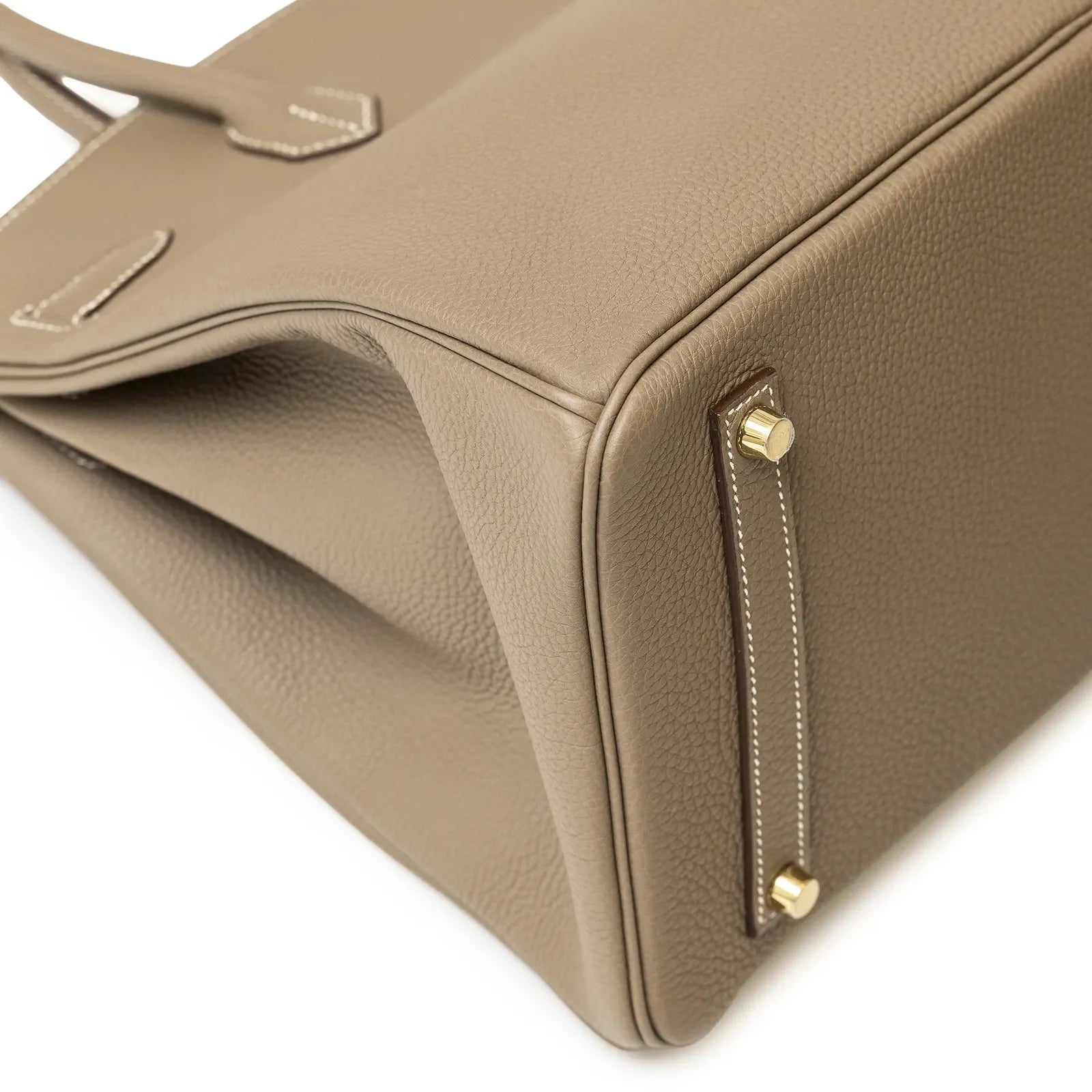 Close-up of bottom corner on Hermès Birkin 35 Etoupe Togo Gold Hardware highlighting leather texture and metal feet.