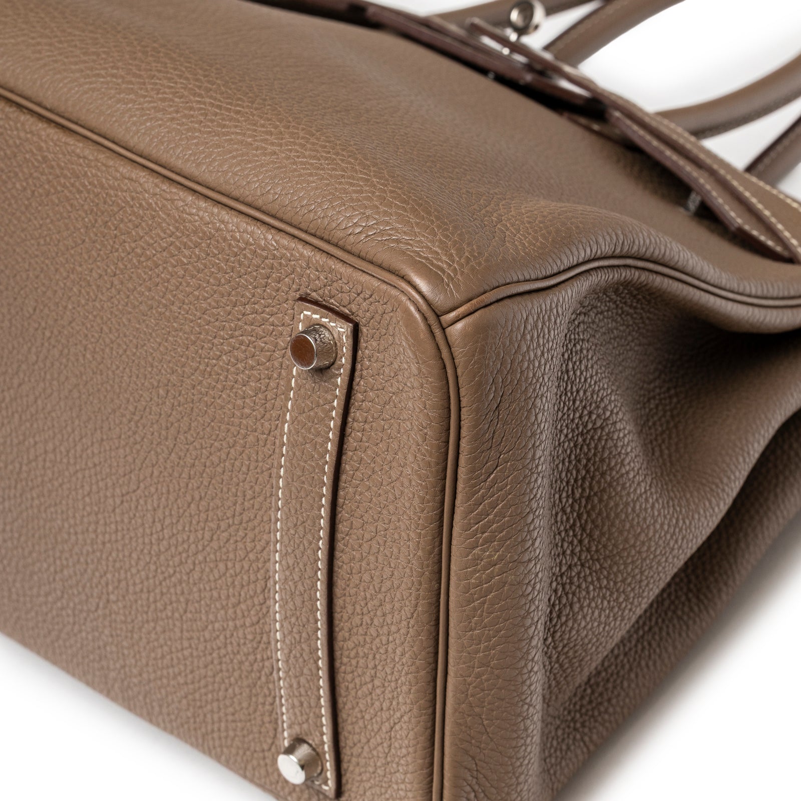 Close-up of bottom corner on Hermès Birkin 35 Etoupe Togo Palladium Hardware showing textured leather and metal feet detail