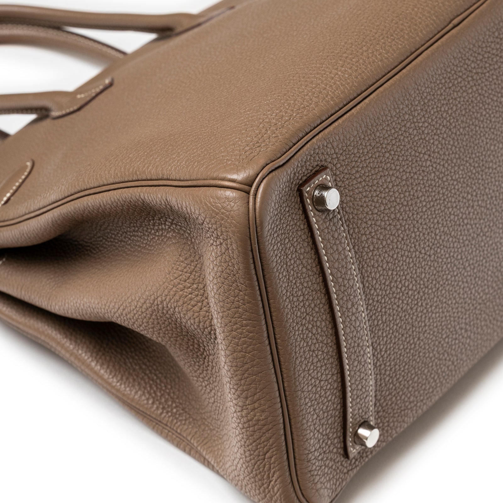 Close-up of base and corner of Hermès Birkin 35 Etoupe Togo Palladium Hardware showing pebbled leather texture and feet detail