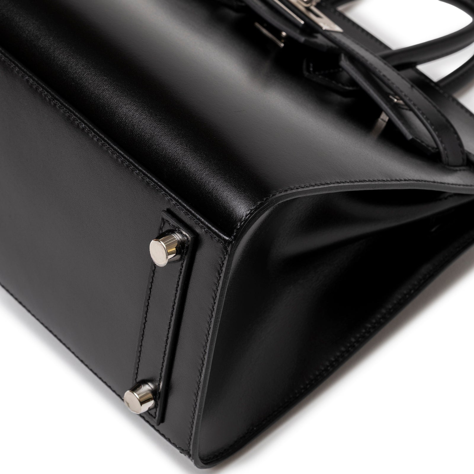 Close-up of base corner and palladium hardware feet on Hermès Birkin Sellier 25 Black Box Palladium Hardware bag