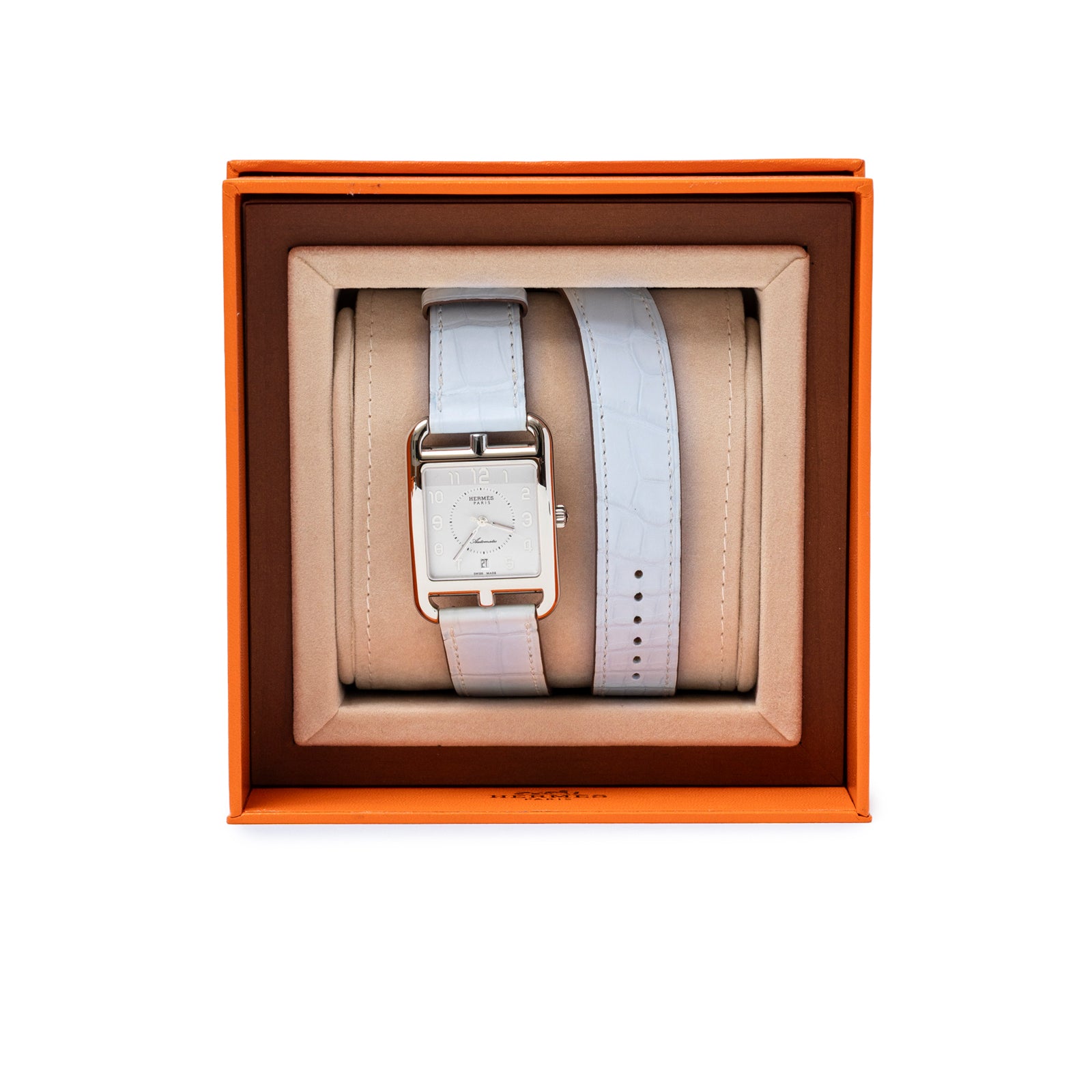 Top-down view of Hermès Cape Cod Automatic Watch Large Model Blue Brume Matte Alligator with extra strap in orange box