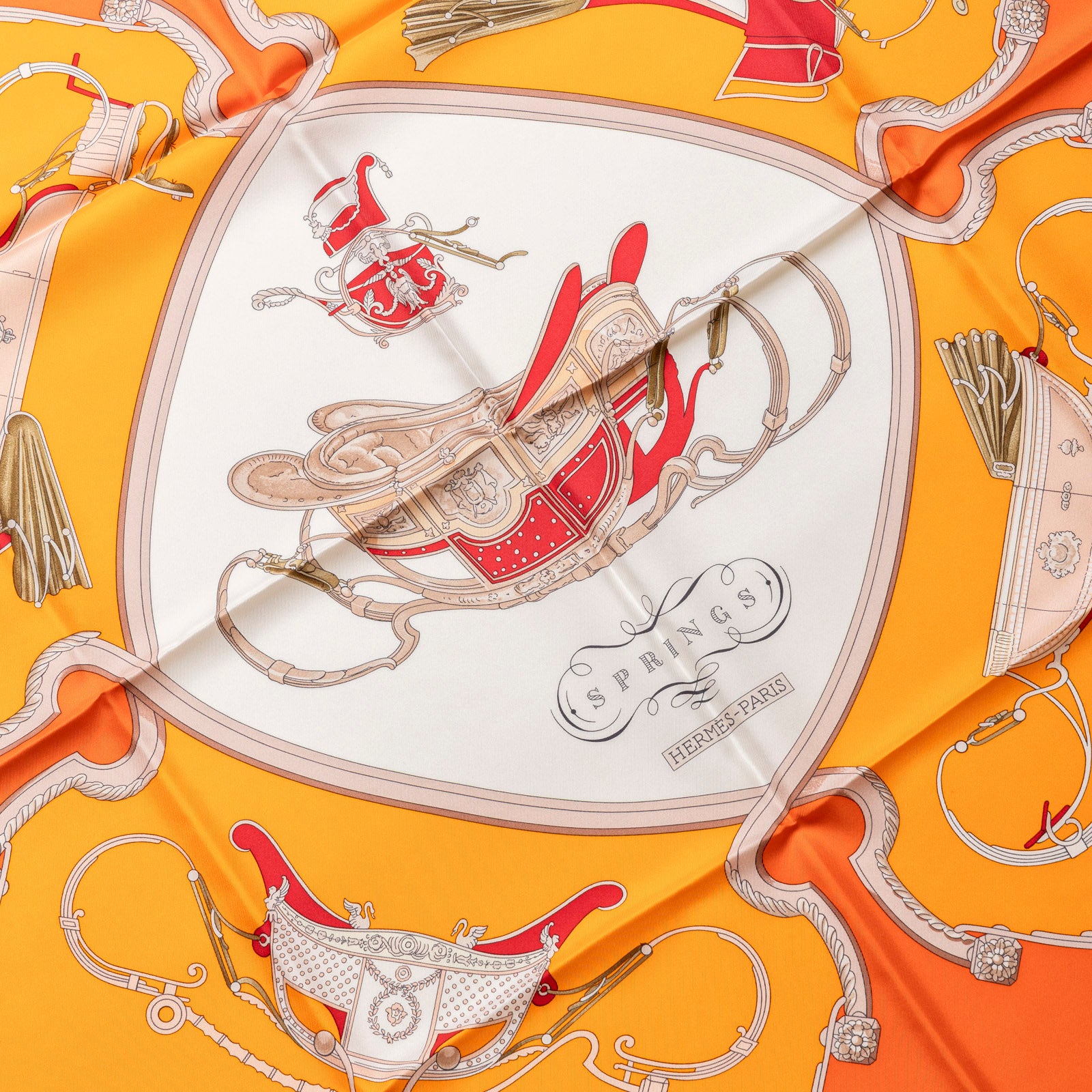 Close-up front view of Hermès Carre 90 Springs Silk Scarf Capucine Orange Blanc with intricate equestrian design