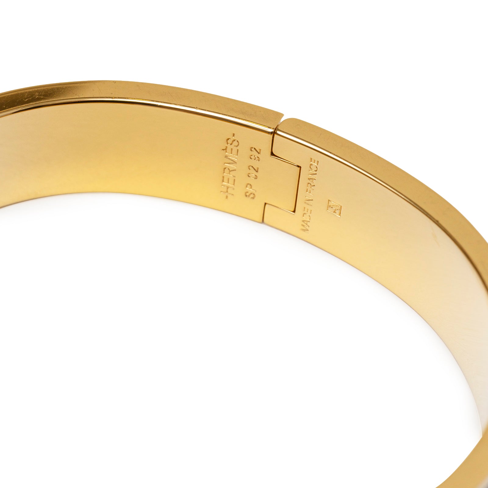 Close-up of Hermès Clic H bracelet PM Black Gold Hardware showing inside hallmark and clasp detail