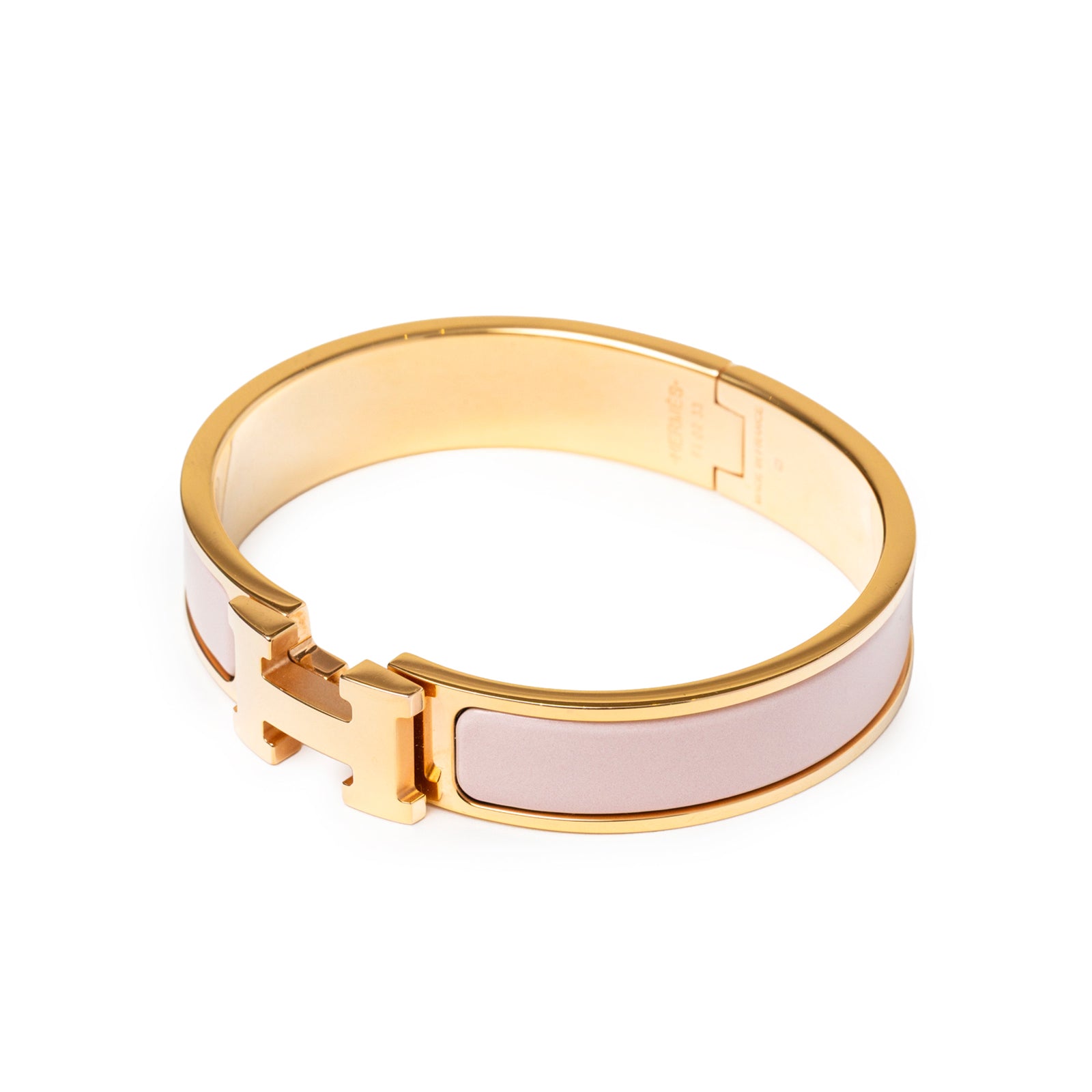 Angled view of Hermès Clic H bracelet PM Pink Gold Hardware featuring soft pink enamel and polished gold trim