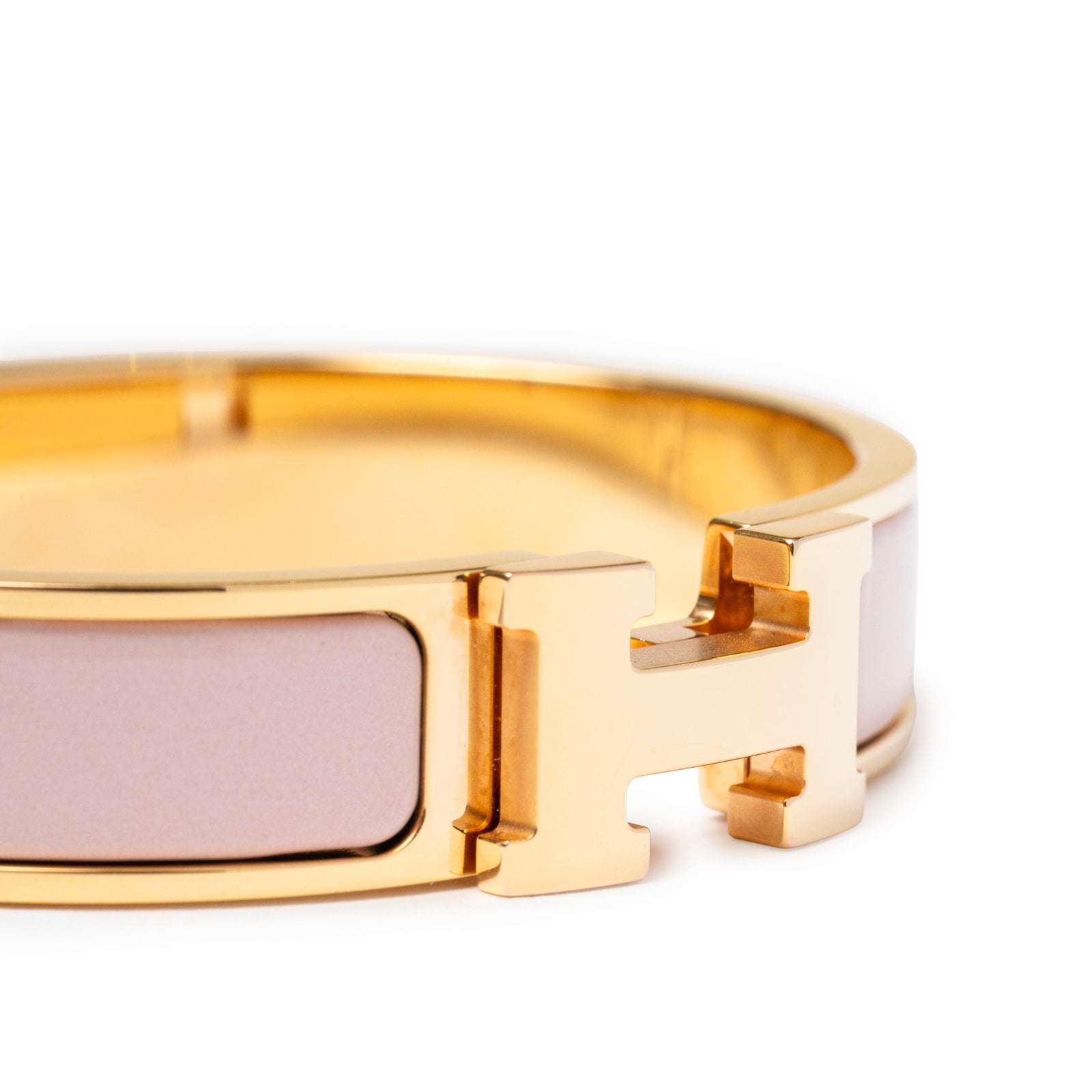 Close-up angled view of Hermès Clic H bracelet PM Pink Gold Hardware showing soft pink enamel and gold clasp details
