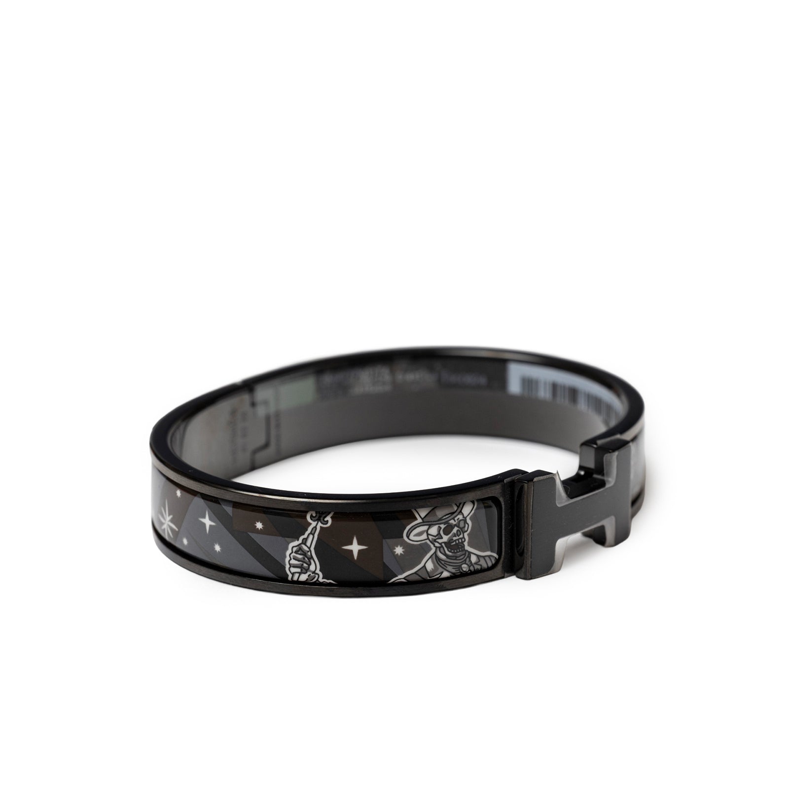 Angled shot of Hermès Clic HH C'est la Fete So Black Bracelet Grand Classique with black enamel and silver motifs clasped