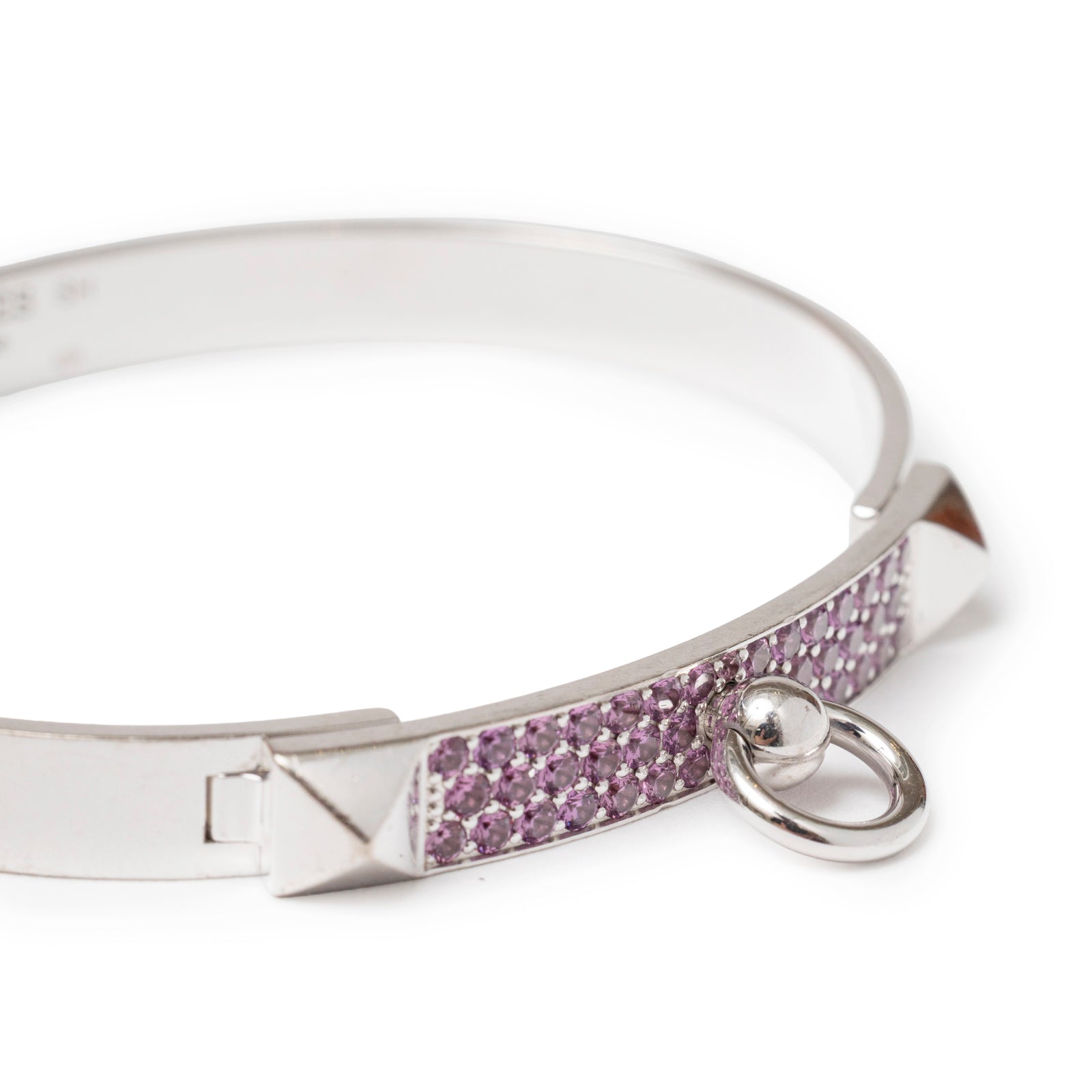 Close-up side view of Hermès Collier de Chien Bracelet Small Model 18K White Gold Pink Sapphire with pavé pink sapphires and ring detail