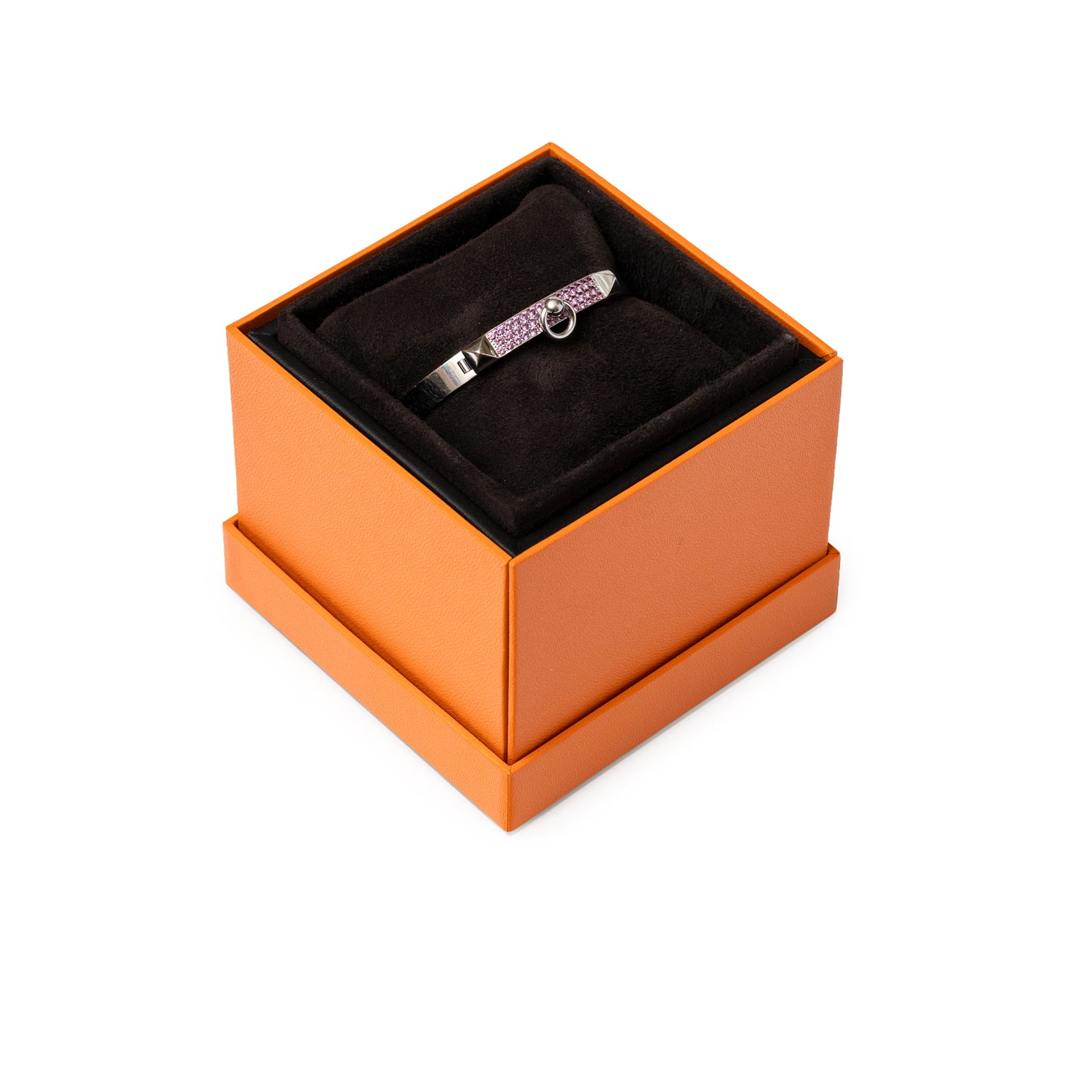 Angled shot of Hermès Collier de Chien Bracelet Small Model 18K White Gold Pink Sapphire in orange box on black cushion