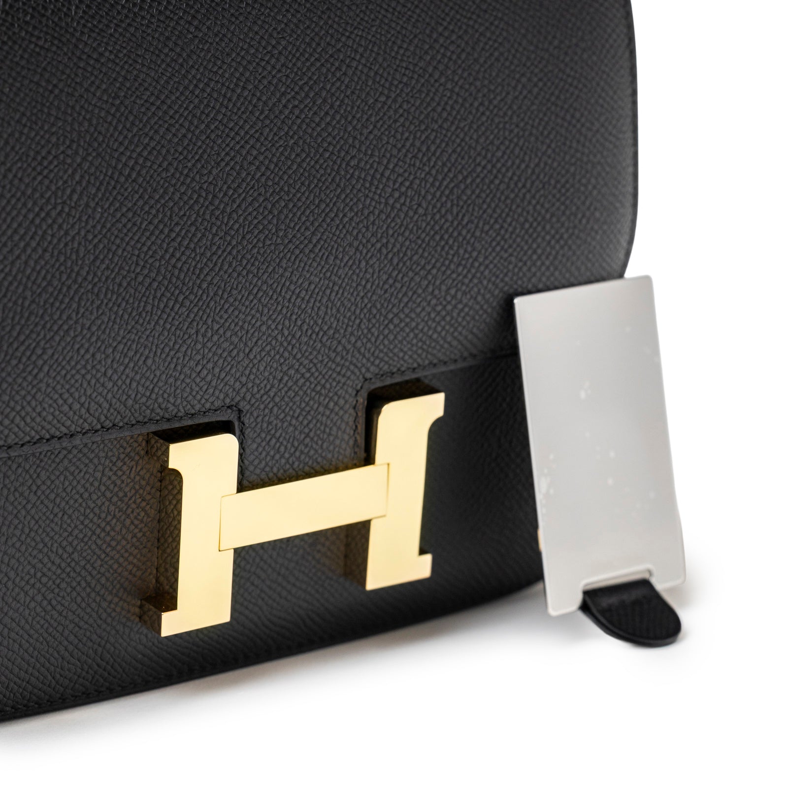 Close-up of Hermès Constance 18 Black Epsom Gold Hardware showing texture and signature clasp detail