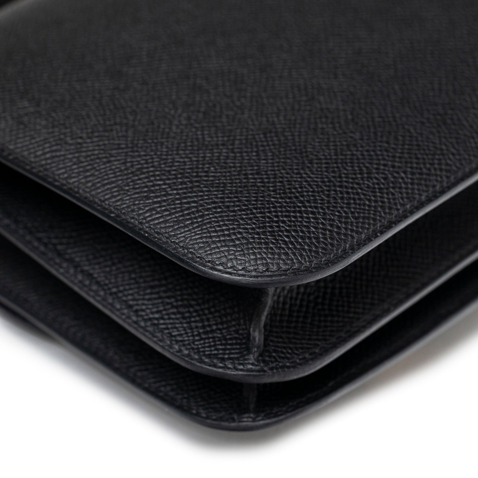 Close-up of corner detailing on Hermès Constance 18 Black Epsom Gold Hardware showing textured leather finish