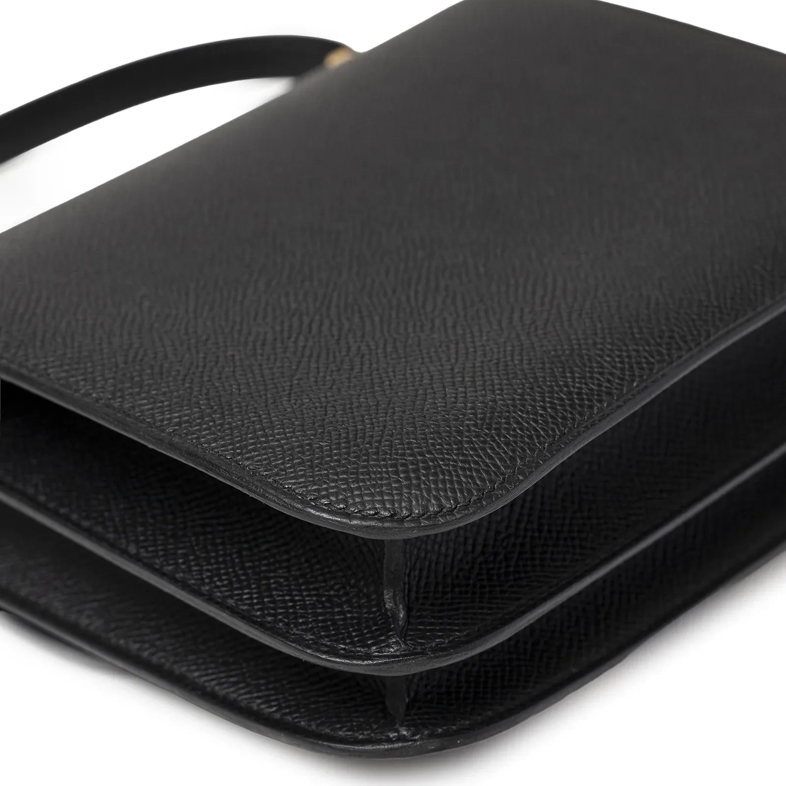 Close-up angled shot of Hermès Mini Constance 18 Black Epsom Gold Hardware showing texture and corners.
