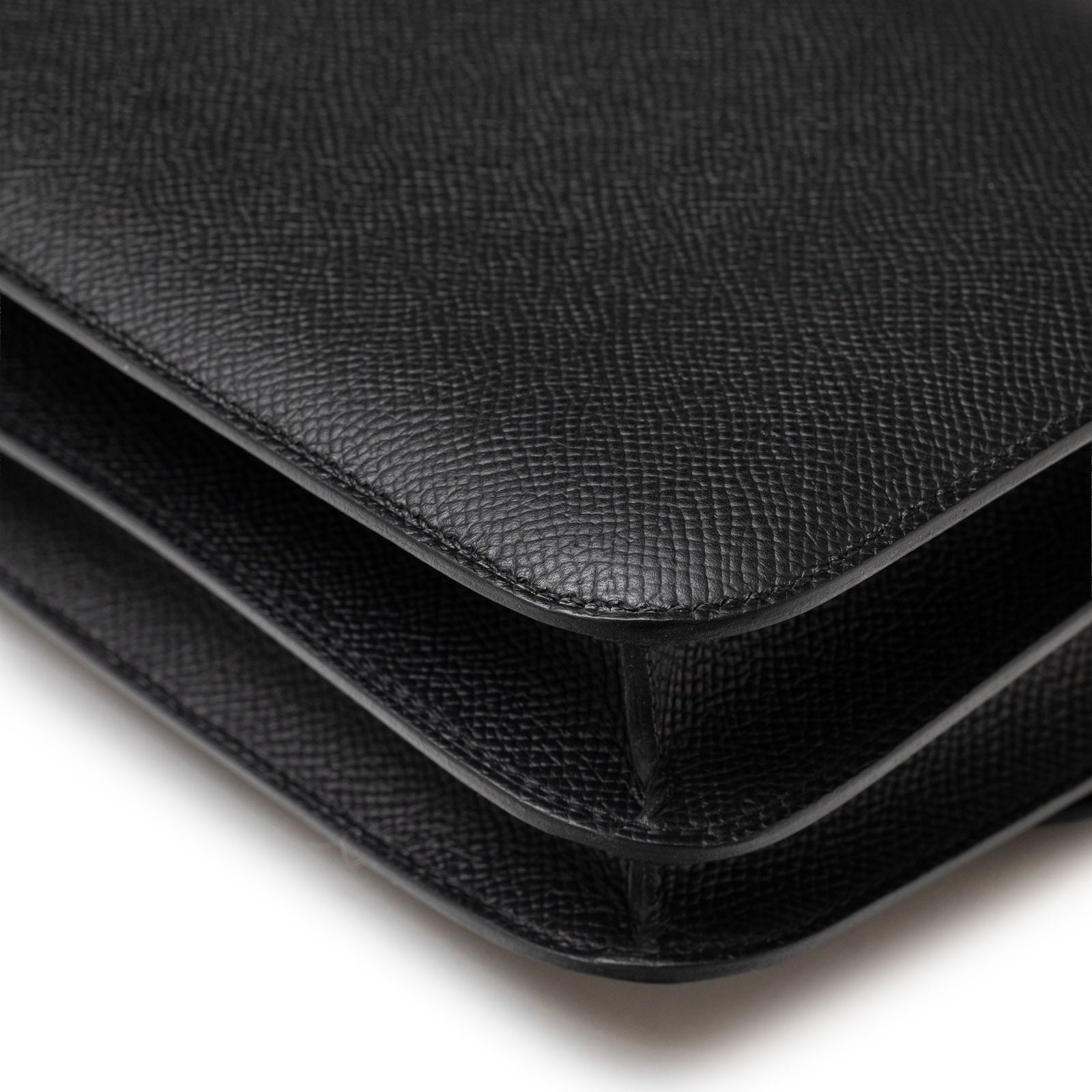 Close-up of corner detail on Hermès Constance 18 Black Epsom Palladium Hardware showing textured leather layers