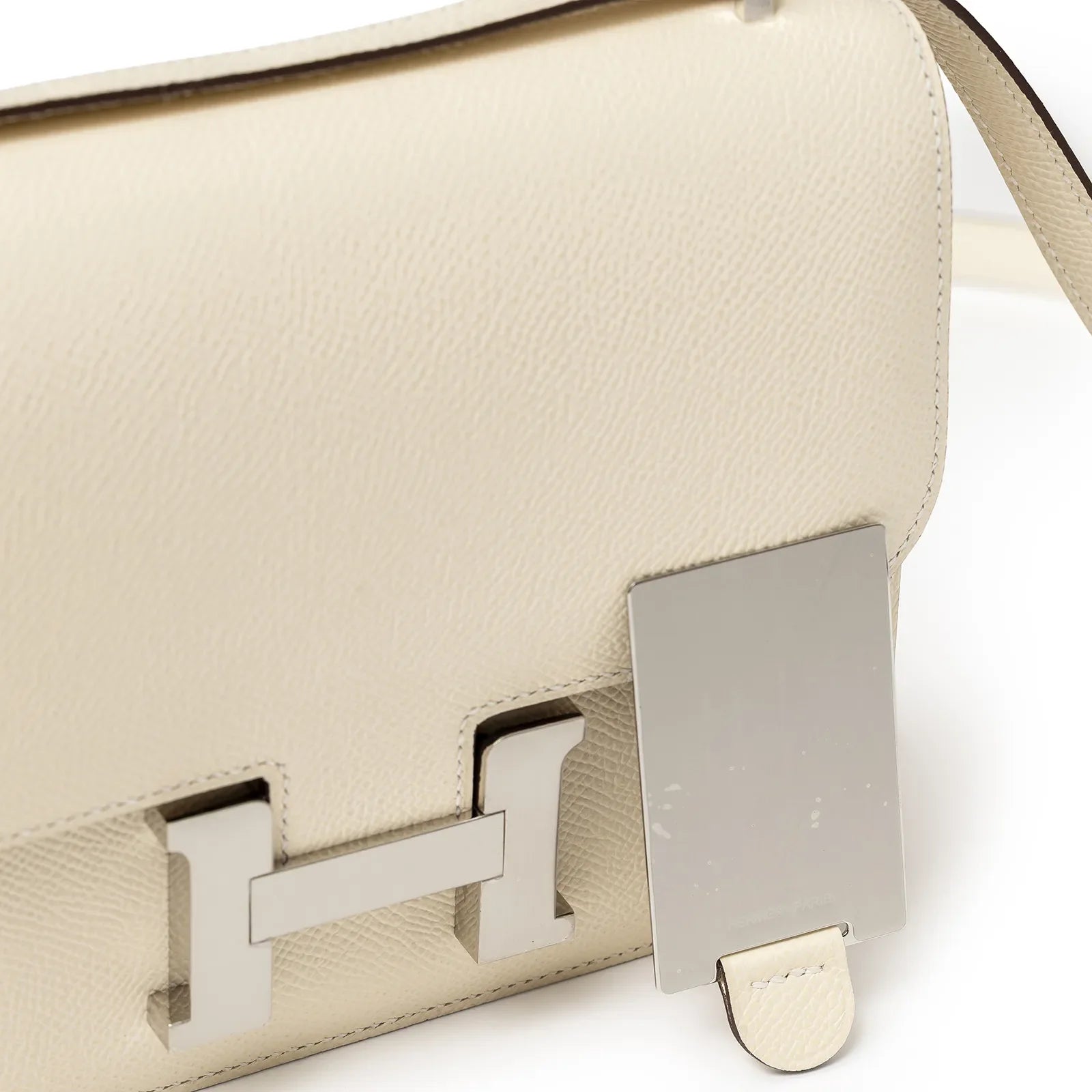 Close-up of Hermès Mini Constance 18 Nata Epsom Palladium Hardware showing the flap and clasp detail