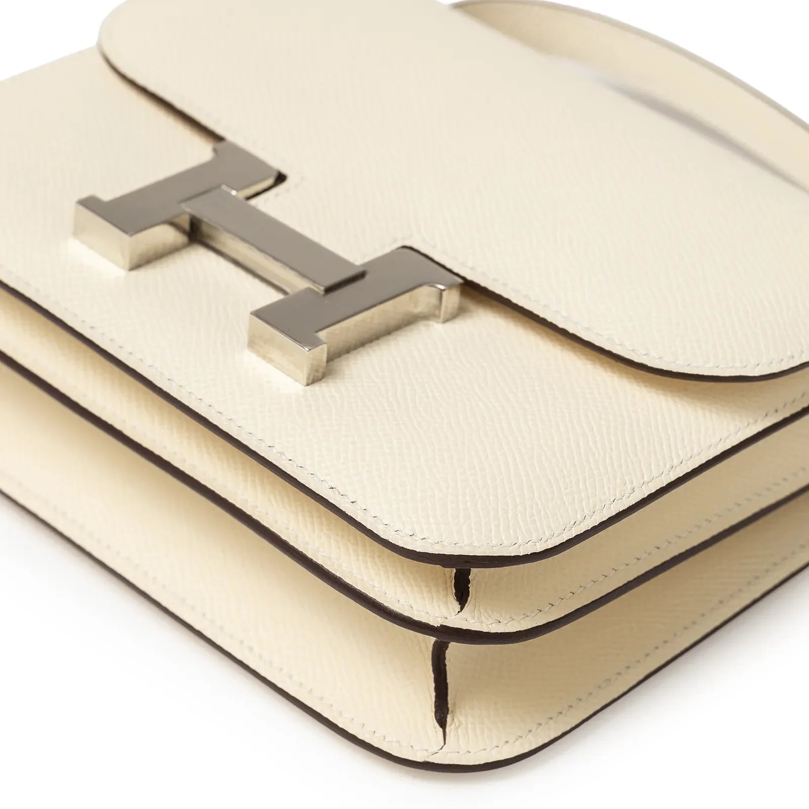 Angled close-up of Hermès Mini Constance 18 Nata Epsom Palladium Hardware showing texture and clasp detail