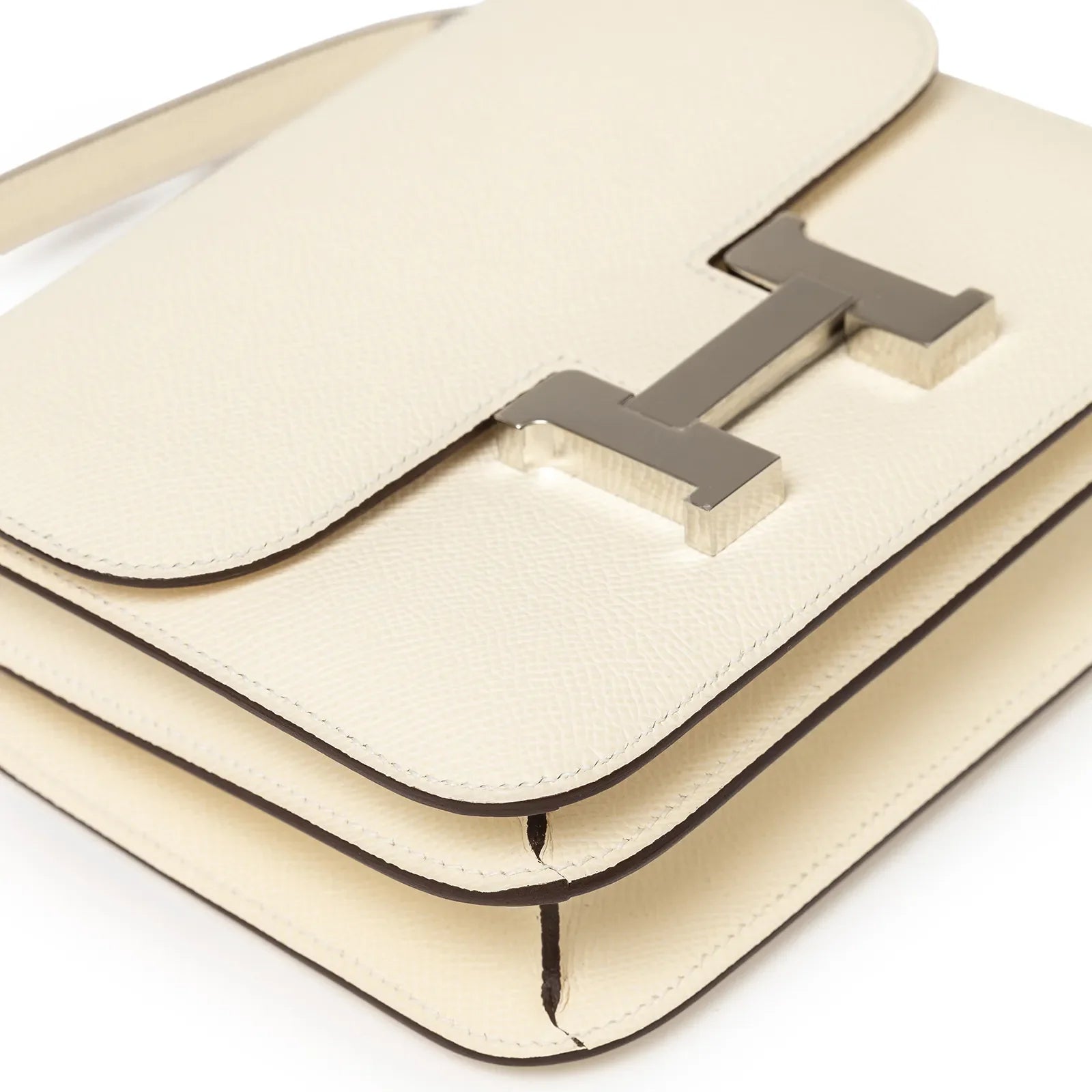 Close-up angled view of Hermès Mini Constance 18 Nata Epsom Palladium Hardware showing texture and clasp details