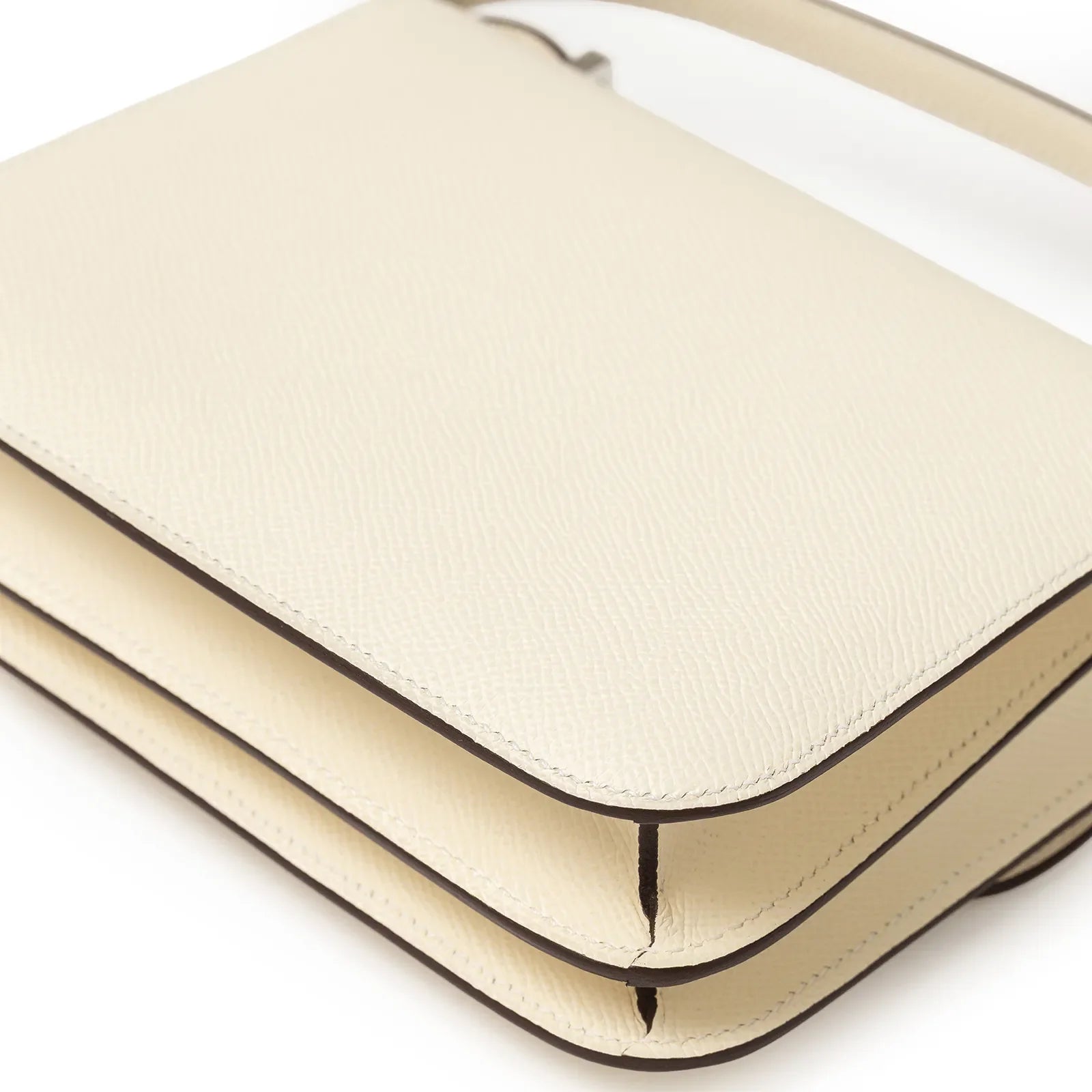 Close-up of Hermès Mini Constance 18 Nata Epsom Palladium Hardware showing clean edges and fine leather texture.