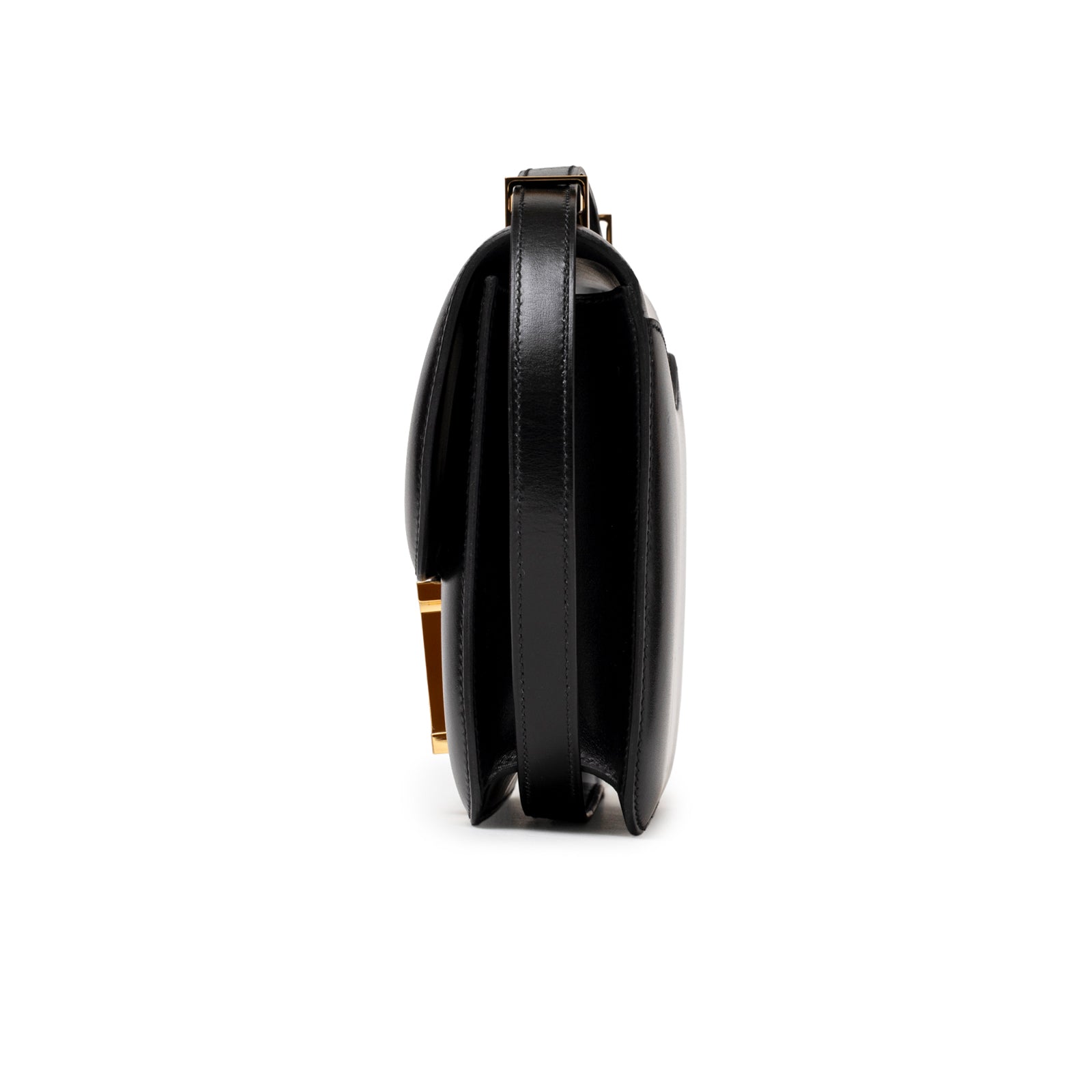 Side profile of Hermès Constance 24 Black Box Gold Hardware highlighting smooth leather and structured silhouette