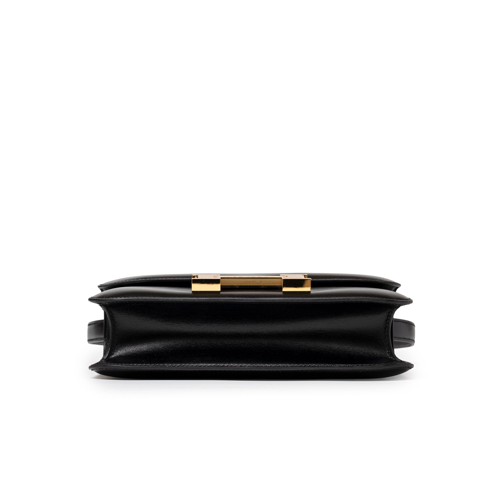 Bottom view of Hermès Constance 24 Black Box Gold Hardware highlighting structured silhouette and smooth leather edges