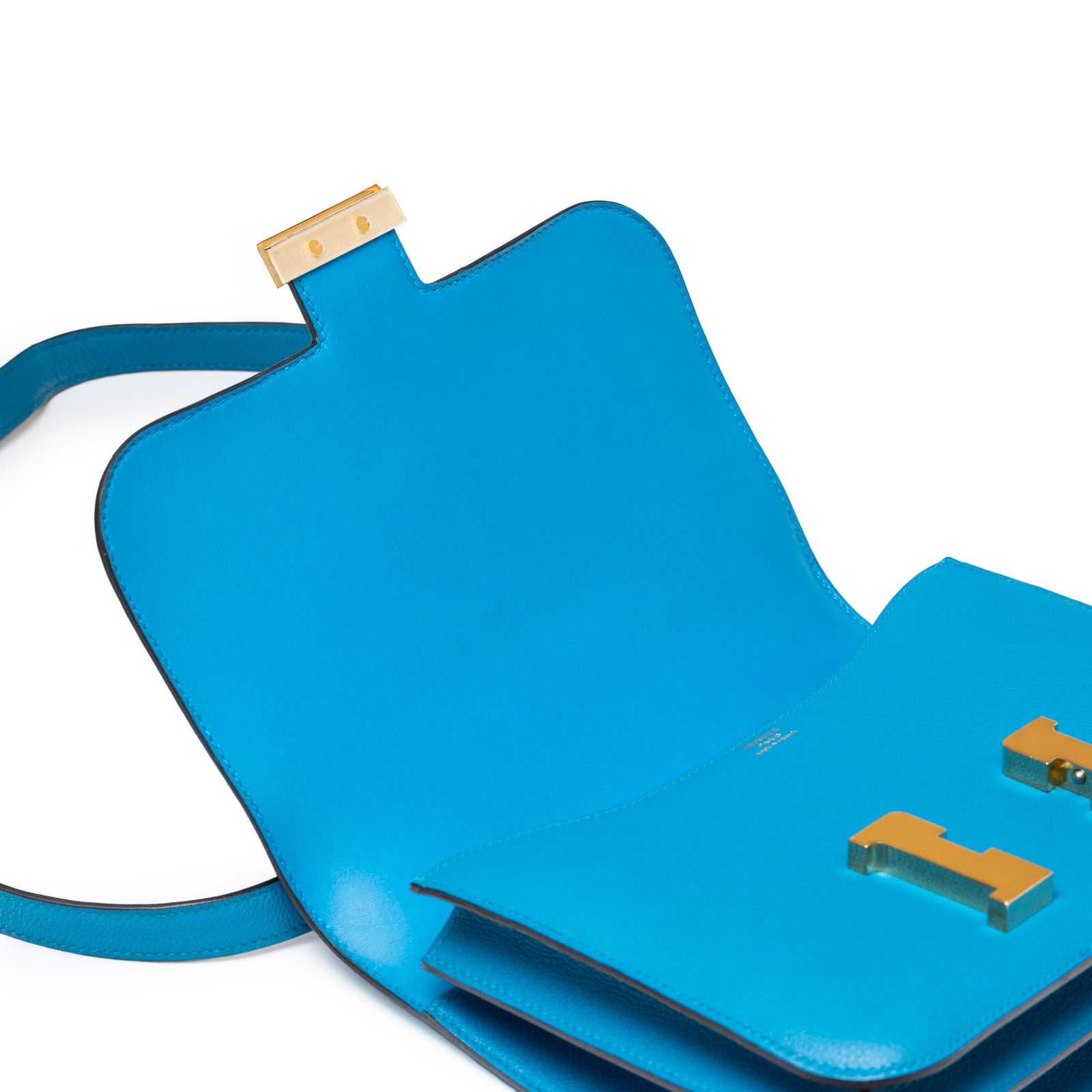 Open interior view of Hermès Constance 24 Blue Zanzibar Evercolor Gold Hardware showing smooth leather and clasp details