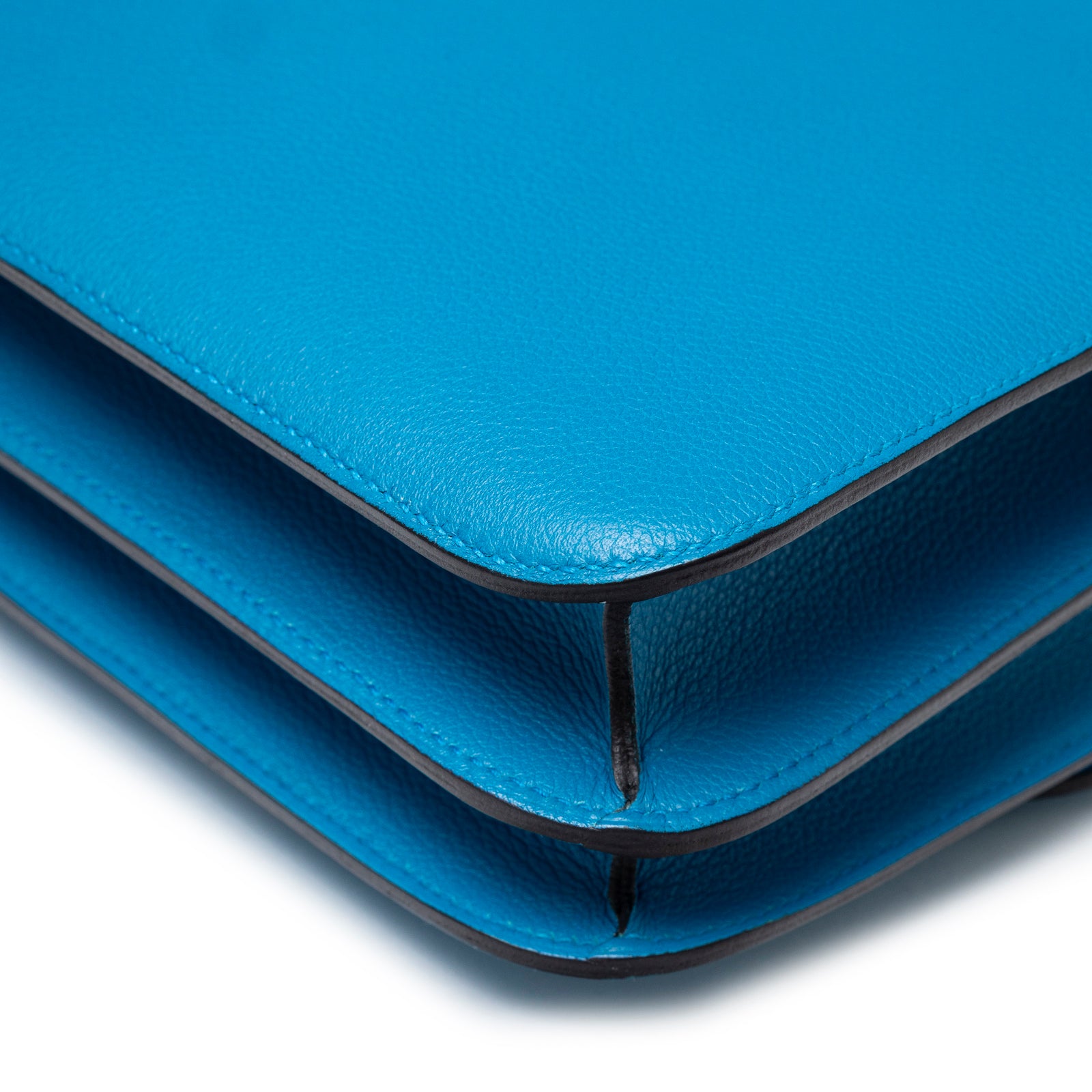 Close-up of corner detail on Hermès Constance 24 Blue Zanzibar Evercolor Gold Hardware showing textured leather and edge finishing