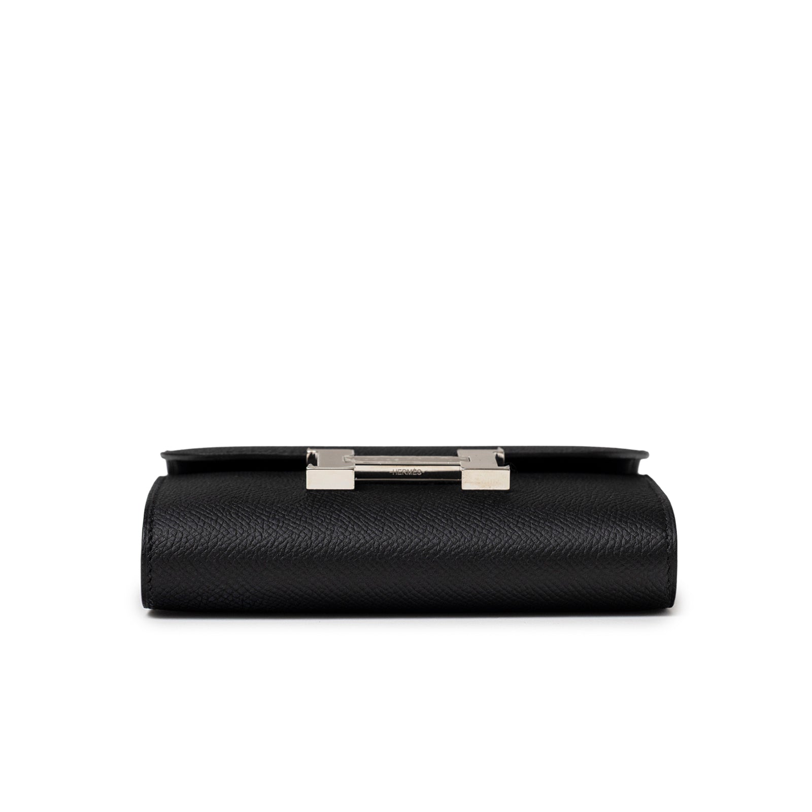 Bottom view of Hermès Constance Compact Wallet Black Epsom Palladium Hardware showing textured leather base and metal clasp edge