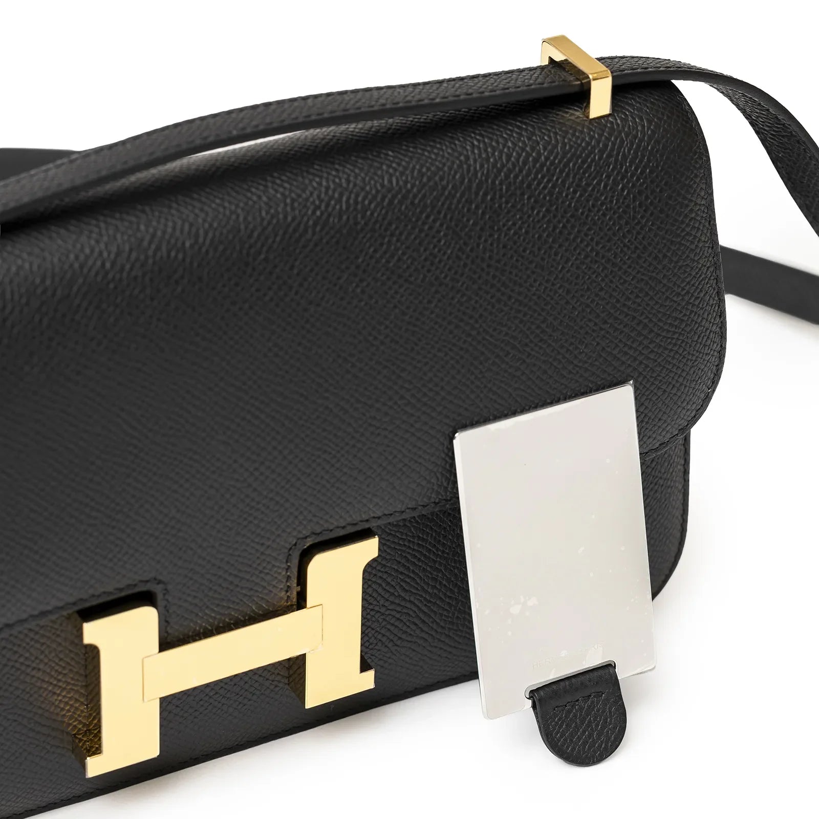 Close-up of Hermès Constance Elan Black Epsom Gold Hardware showing front flap and gold clasp detail
