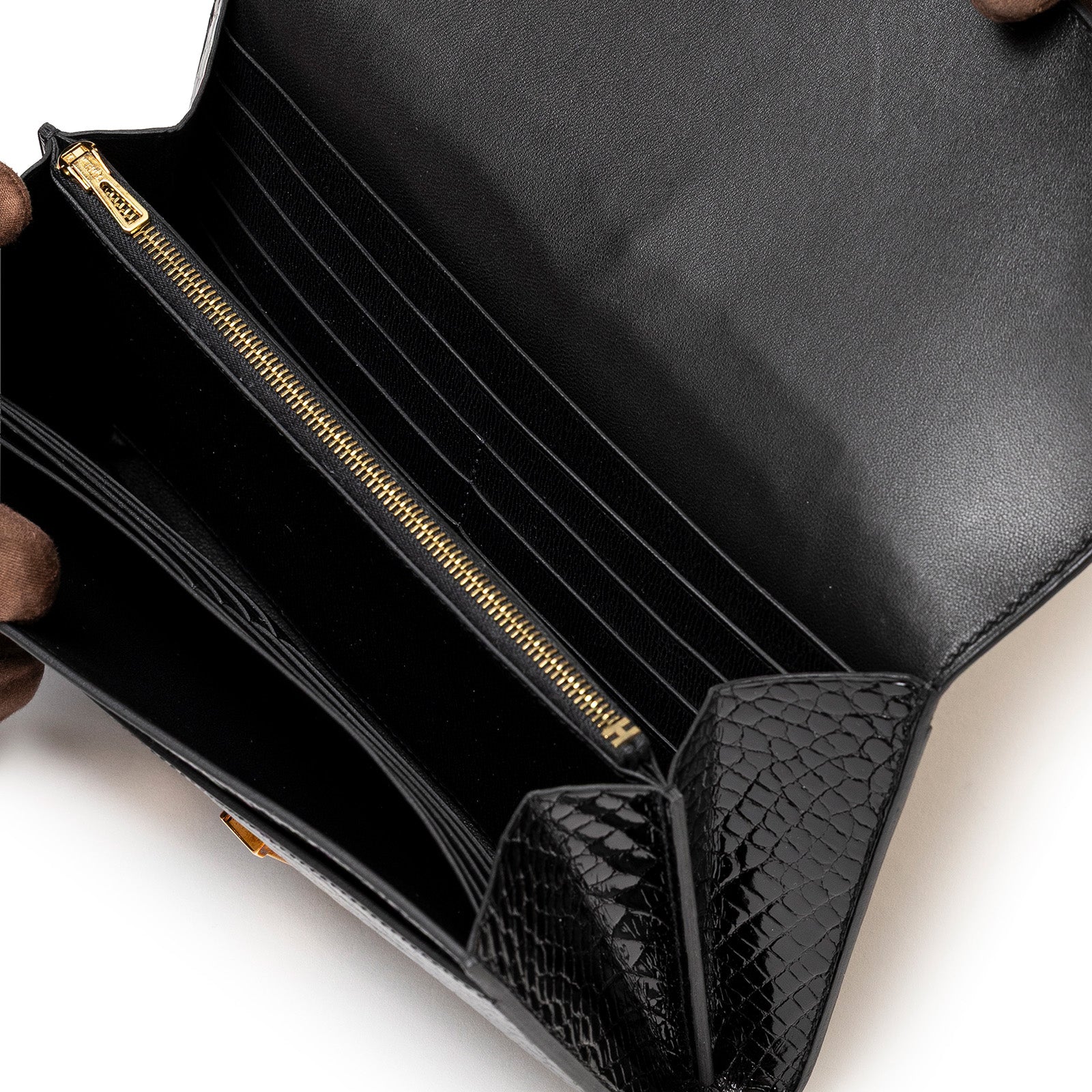 Interior view of Hermès Constance Long Wallet Black Shiny Alligator Rose Gold Hardware showing card slots and zippered pocket