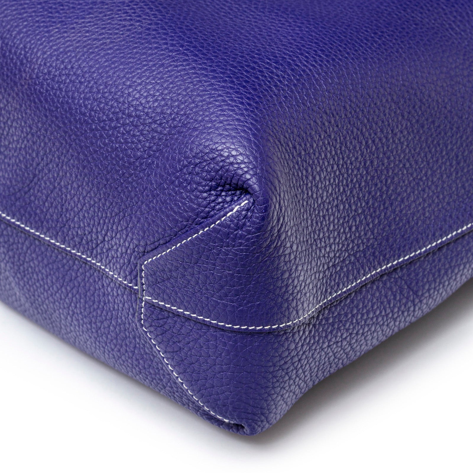Close-up of Hermès Double Sens Reversible Bicolor Shoulder Bag Clemence Violet/Blue showing detailed corner stitching and texture