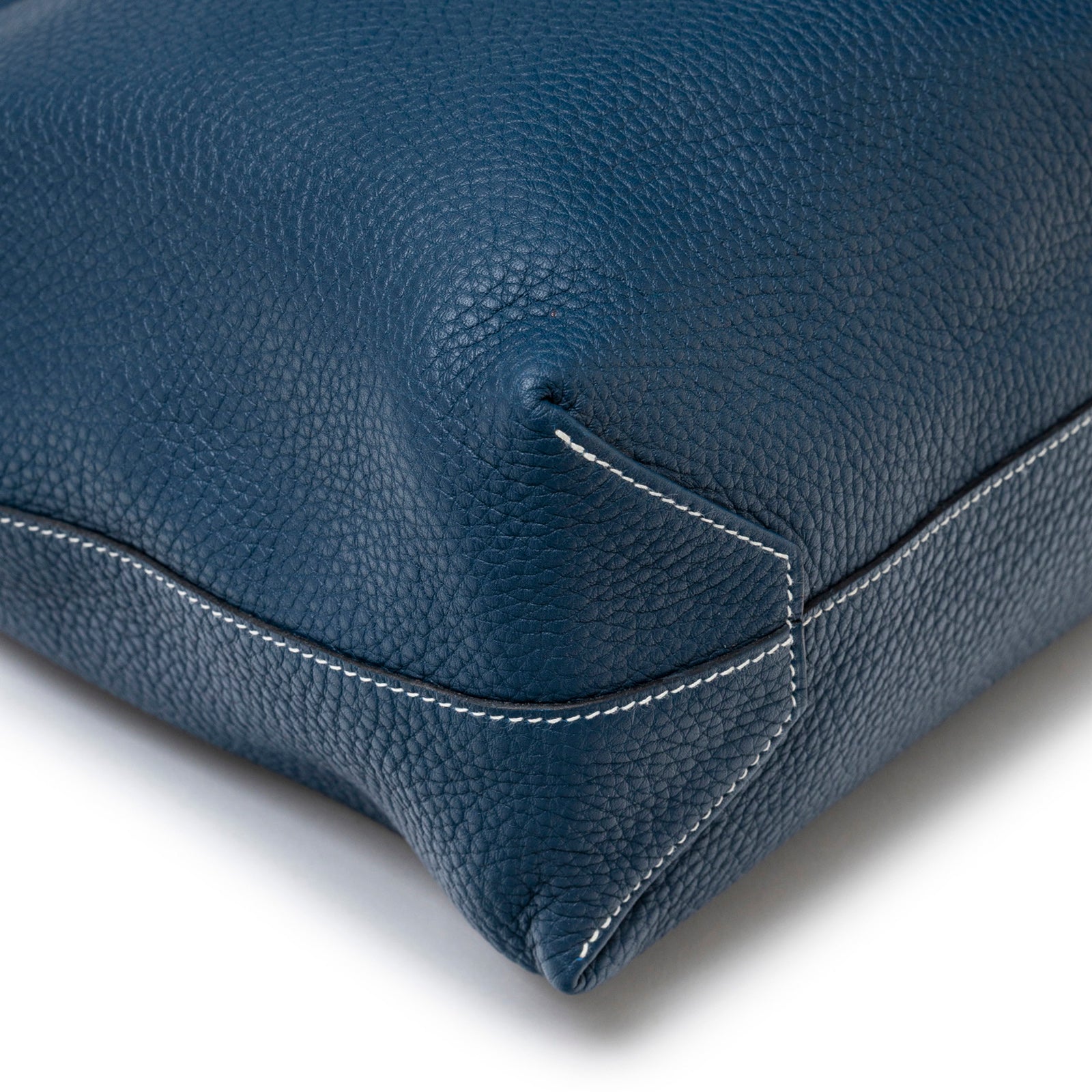Close-up of corner stitching and blue leather texture on Hermès Double Sens Reversible Bicolor Shoulder Bag Clemence Violet/Blue