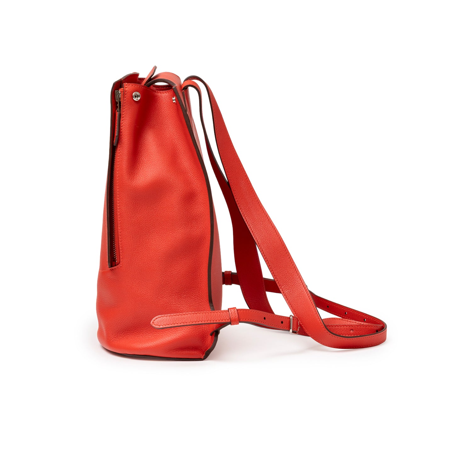Side profile of Hermès Gr24 Backpack Rouge Tomate Evercolor Palladium Hardware showcasing vibrant red leather and adjustable straps