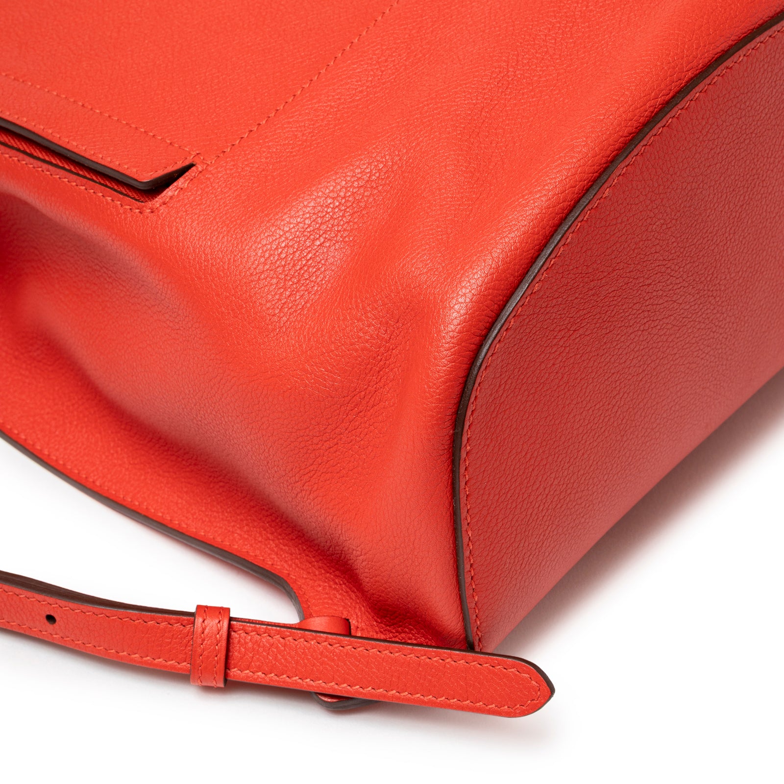 Close-up of Hermès Gr24 Backpack Rouge Tomate Evercolor Palladium Hardware showing textured leather and strap edge detail