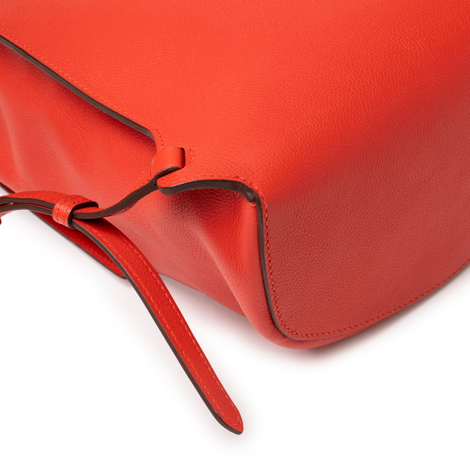 Close-up of Hermès Gr24 Backpack Rouge Tomate Evercolor Palladium Hardware showing supple leather and strap end detail